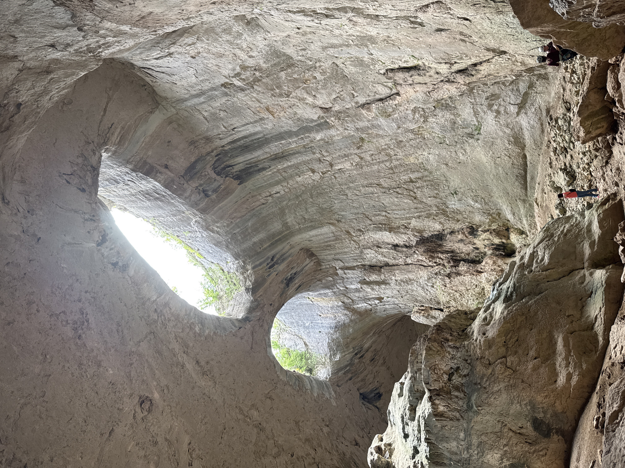 Natural light illuminates Devetashka Cave interior through roof openings