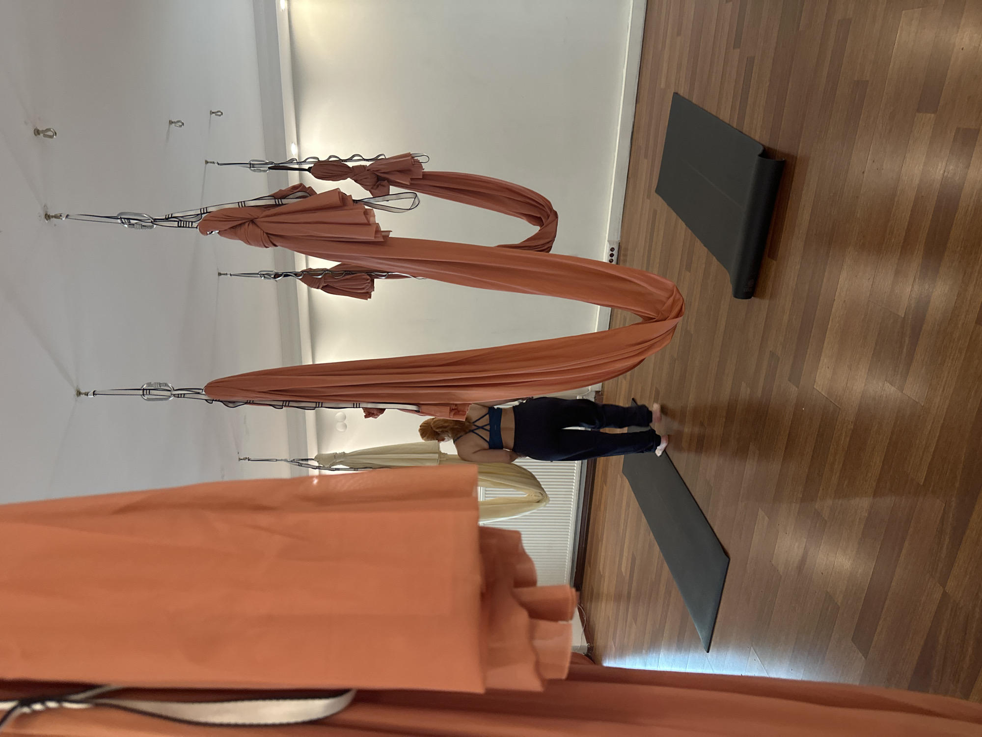 Woman practices aerial yoga at Esenyurt studio