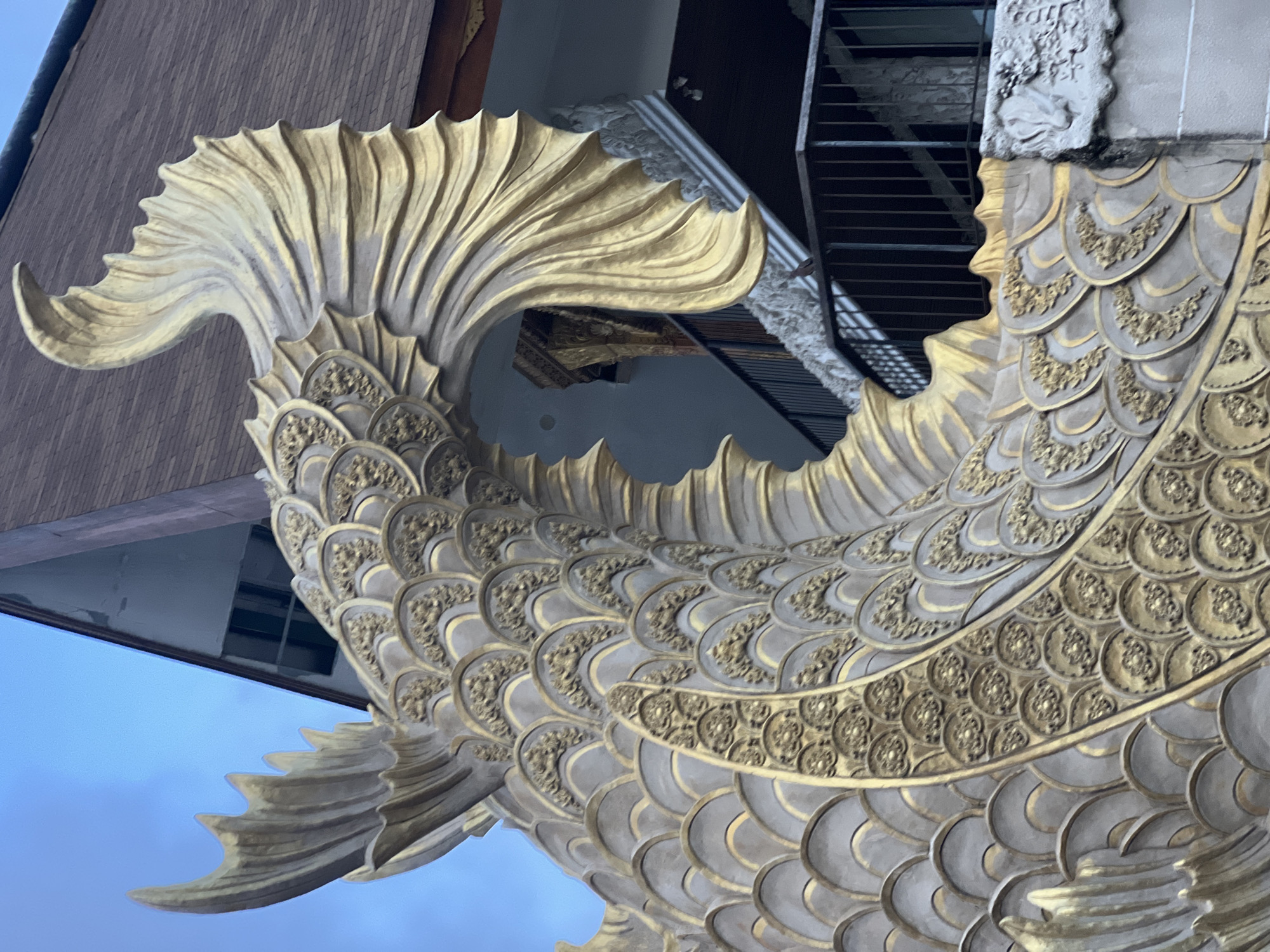 Witness documents waterside building with mythical sculptures in Denpasar