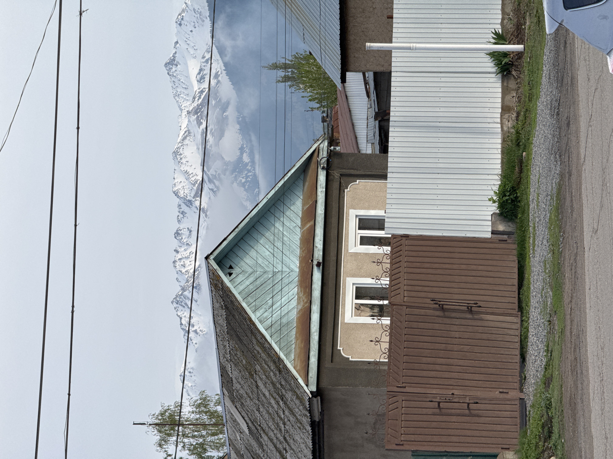 Street view captured in Karakol City against mountain backdrop