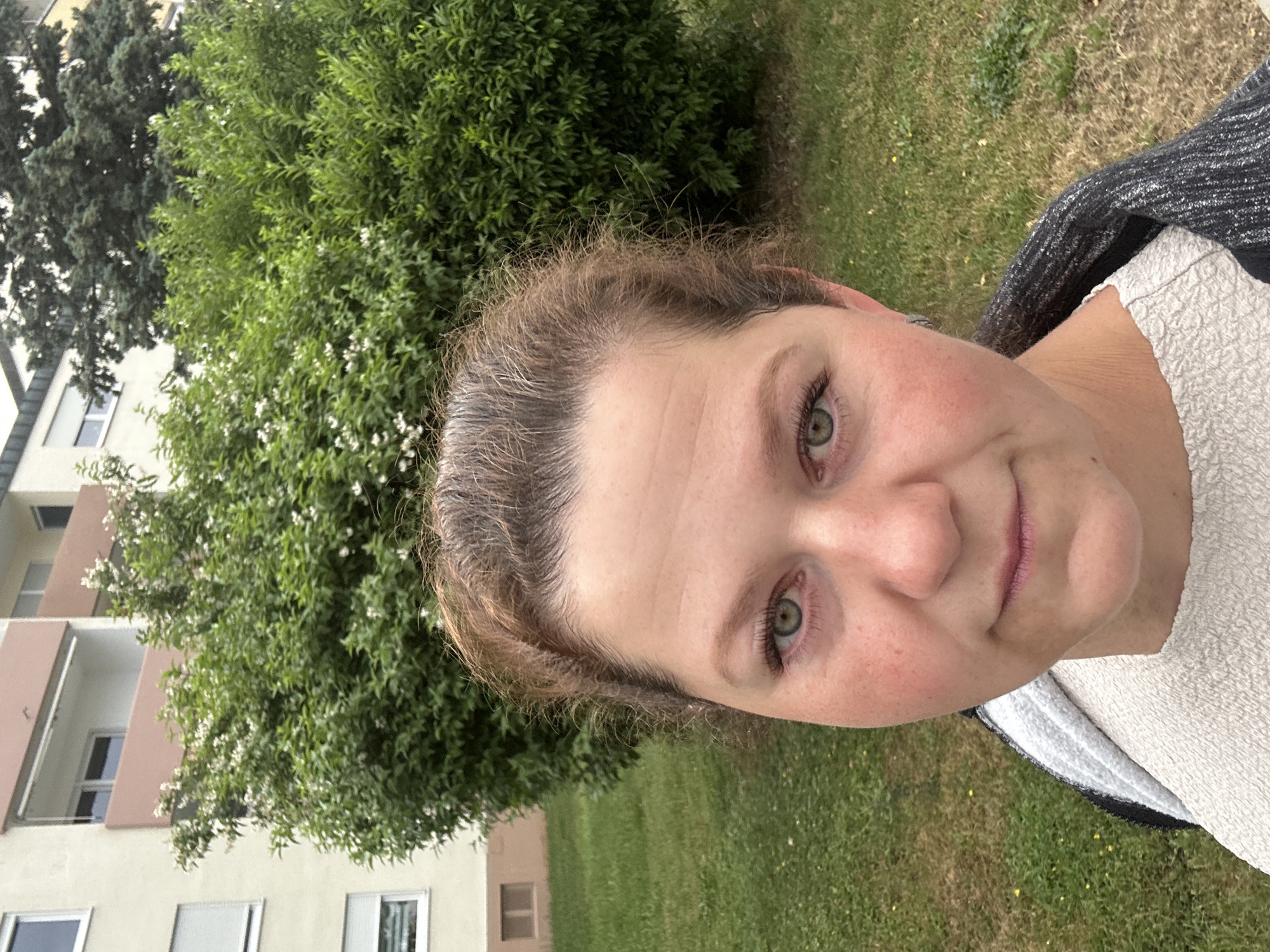 Woman documents morning dog walk amid blooming flowers in Ergolding