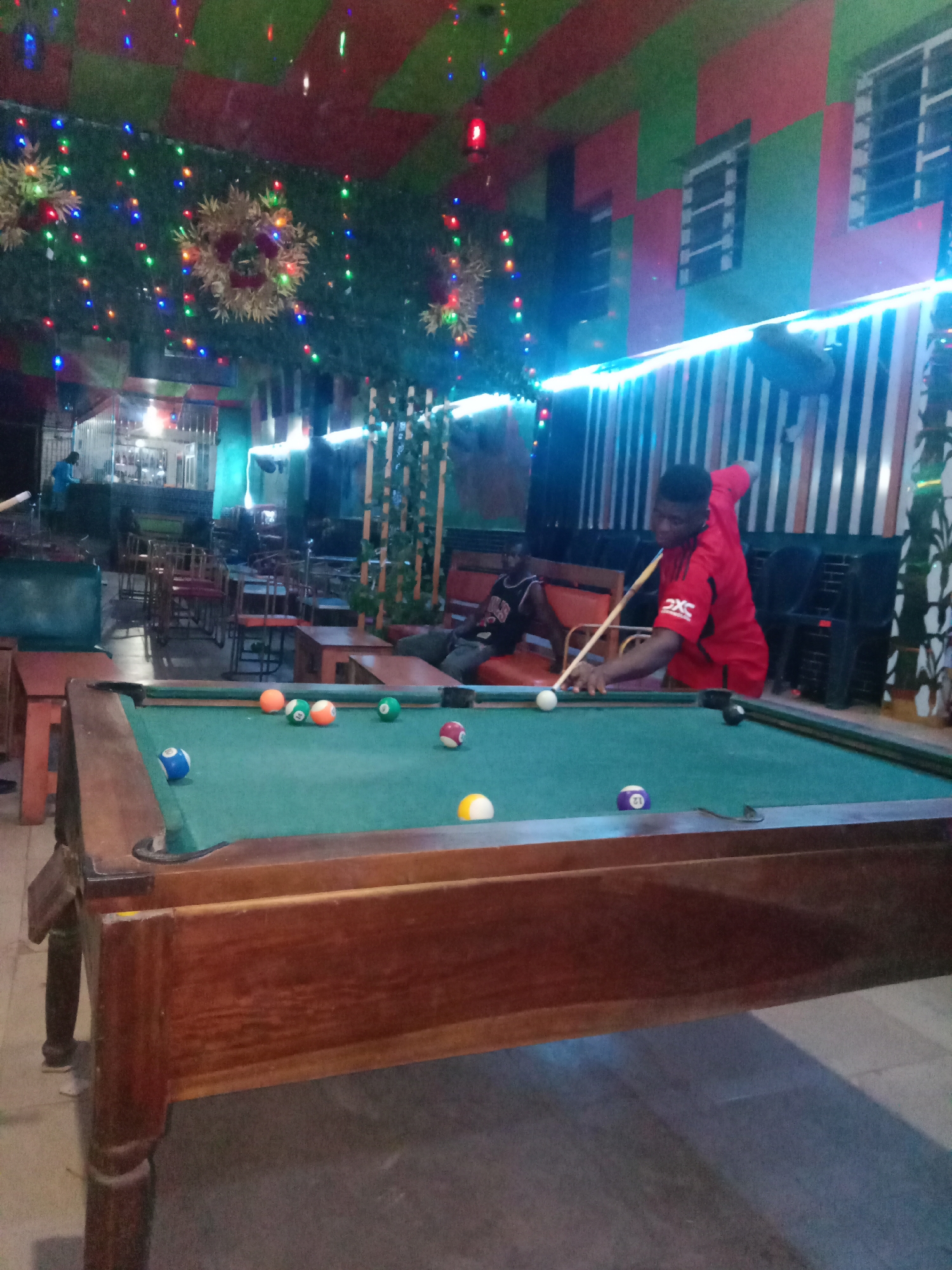 Man plays pool at entertainment venue in Onitsha