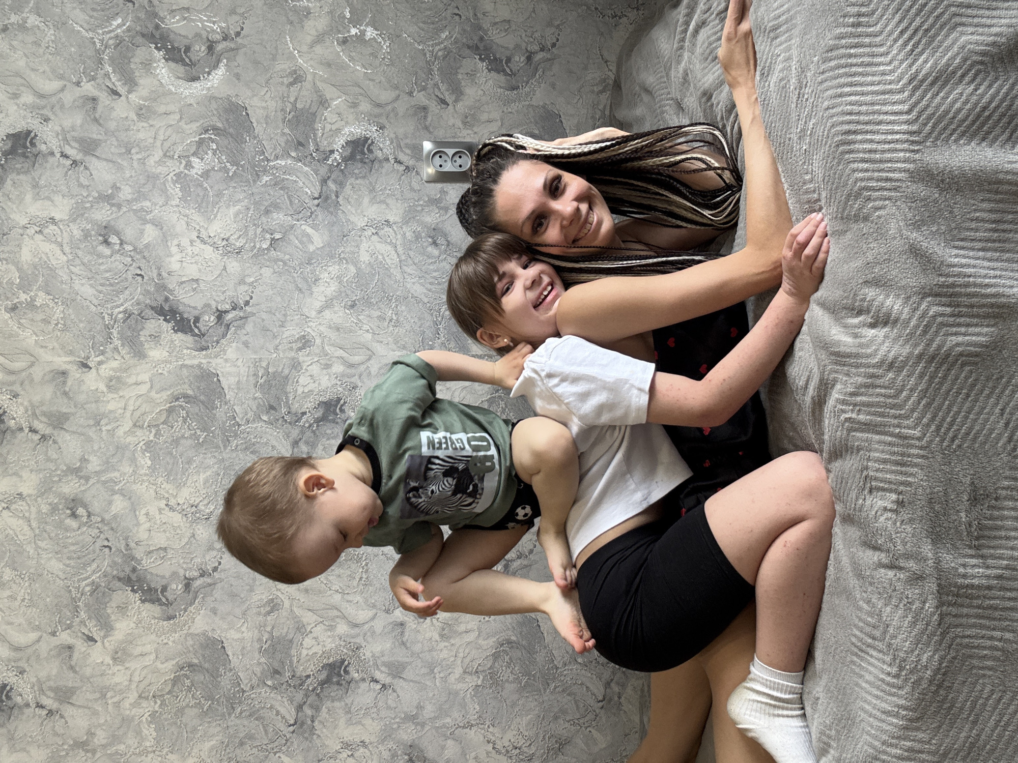 Family shares playful moment indoors in Zhukovo, Russia