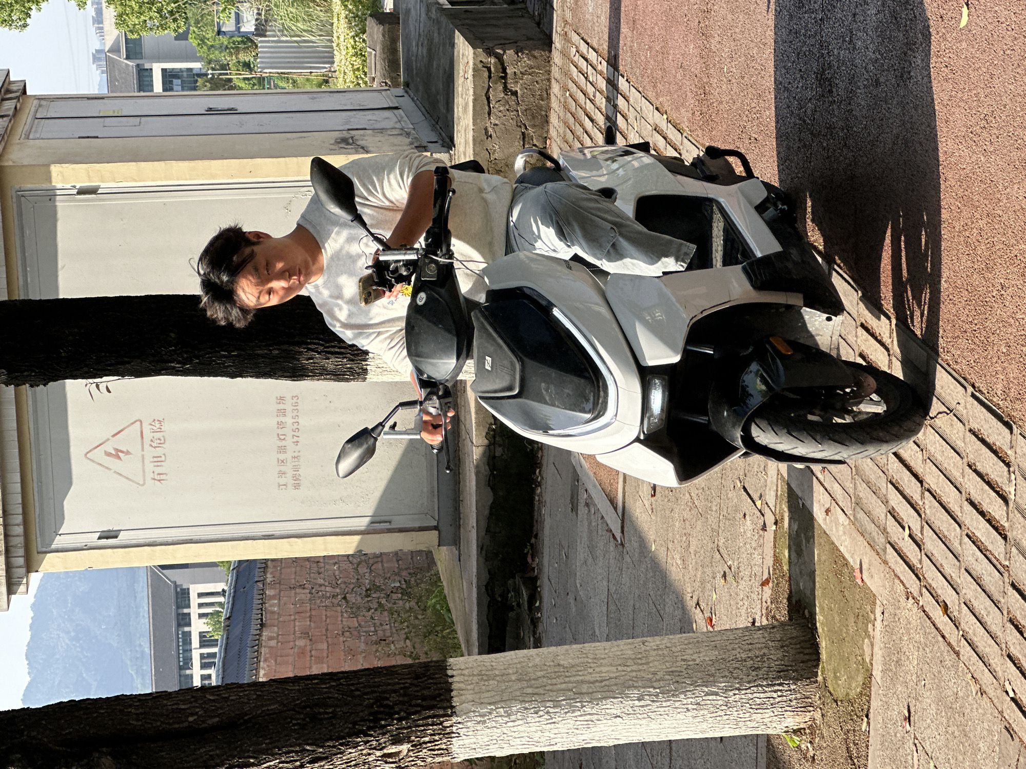 Scooter riders spotted on sunny morning in Jiangjin, China