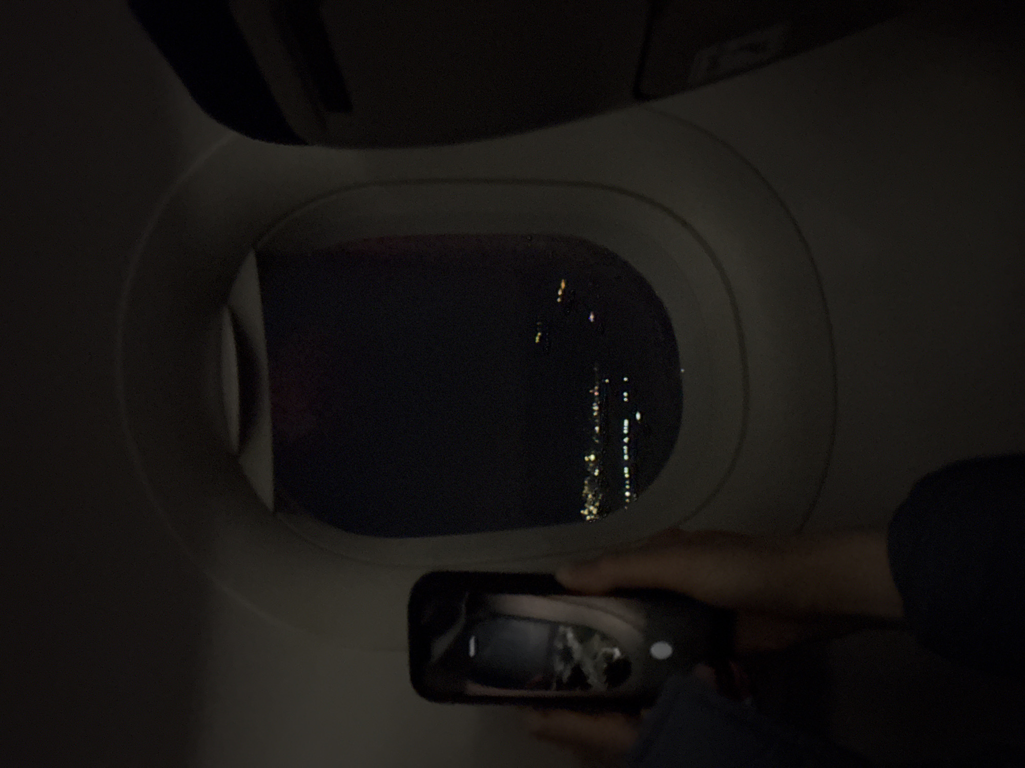Airplane passenger photographs through window during night flight over Armenia