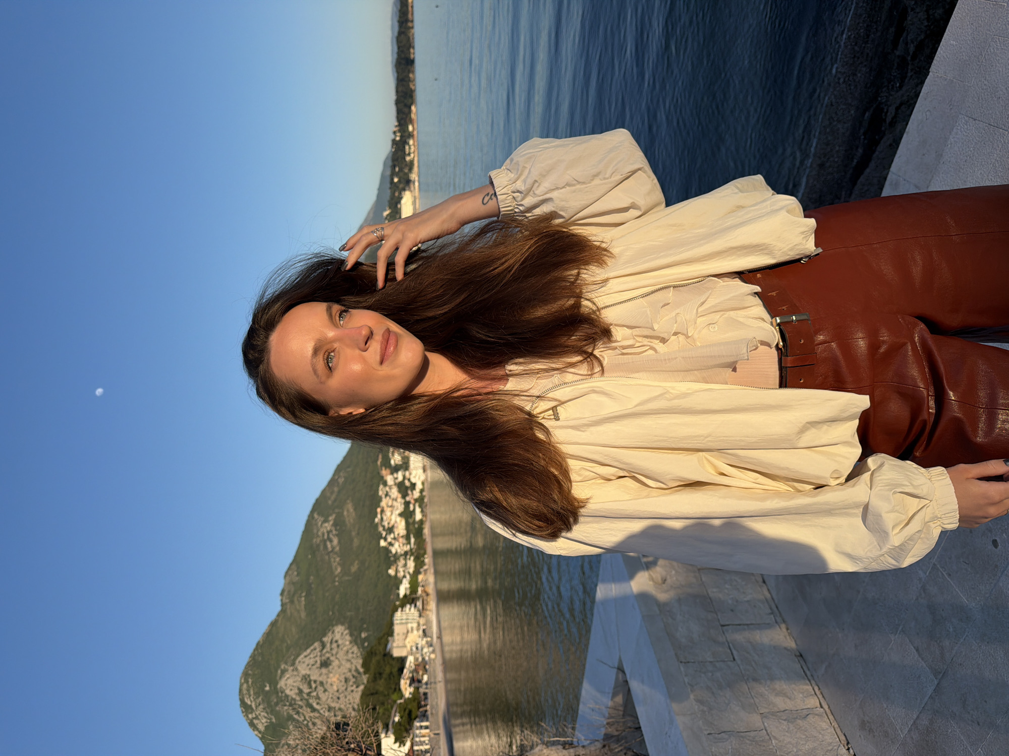 Woman poses for photos during sunset in Montenegro coastal town