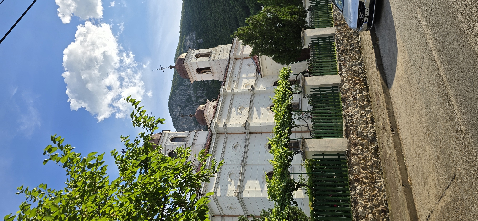 White domed church in green hills on a sunny day