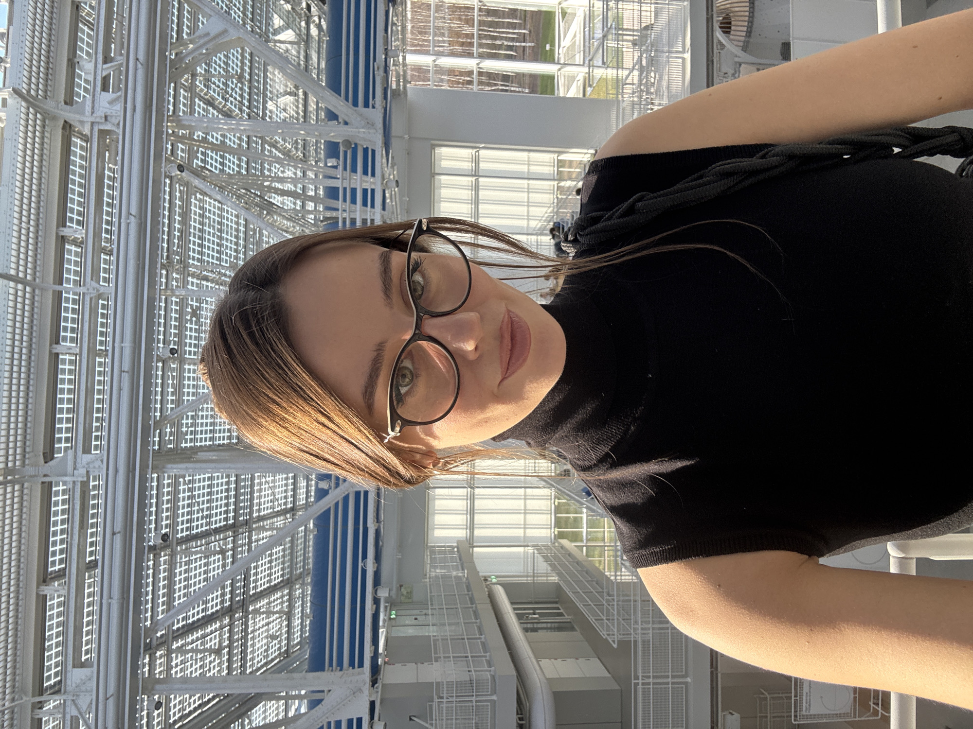Woman takes selfie near modern architecture in Moscow