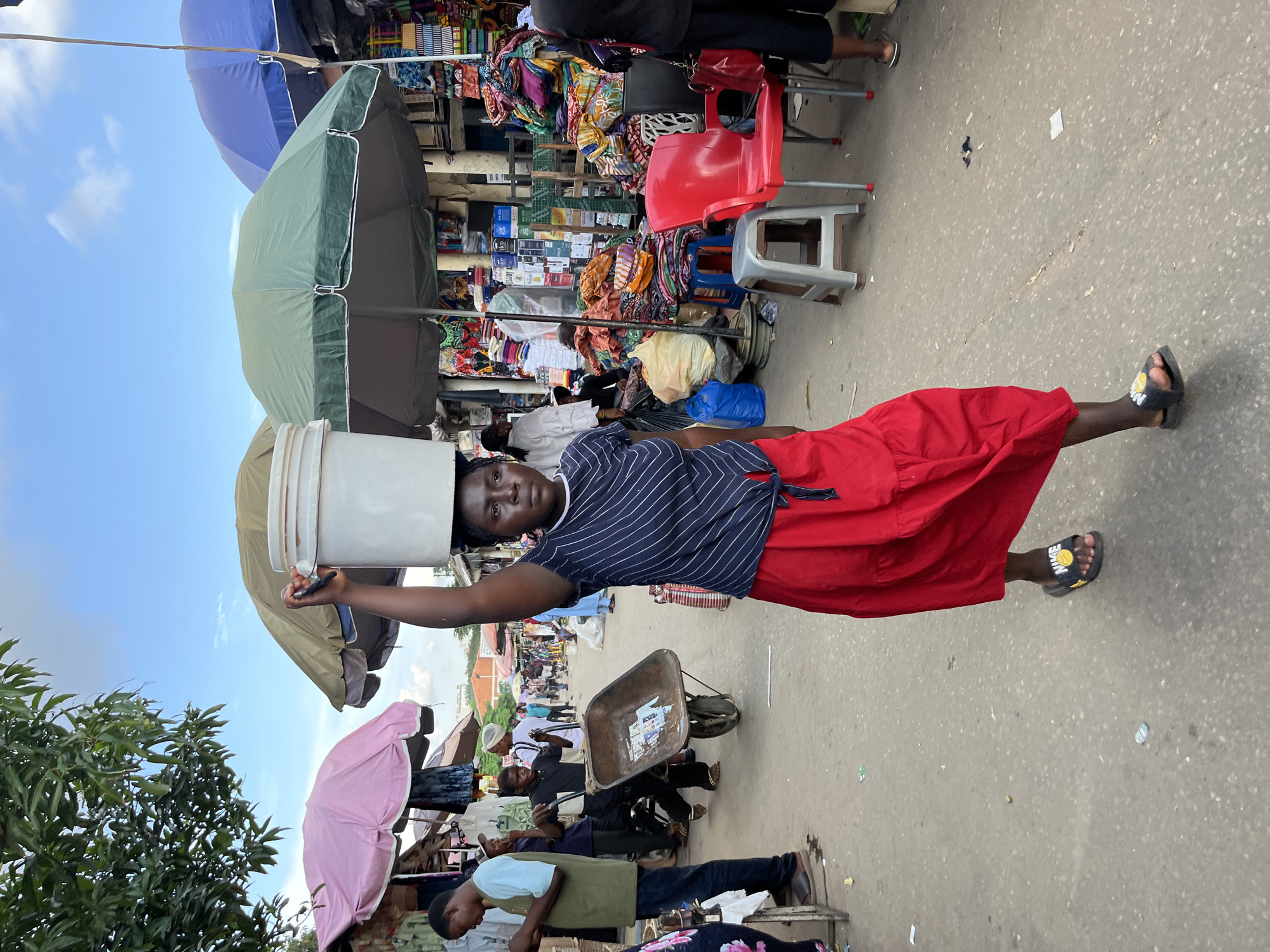 Abuja street market buzzing with vendors and shoppers