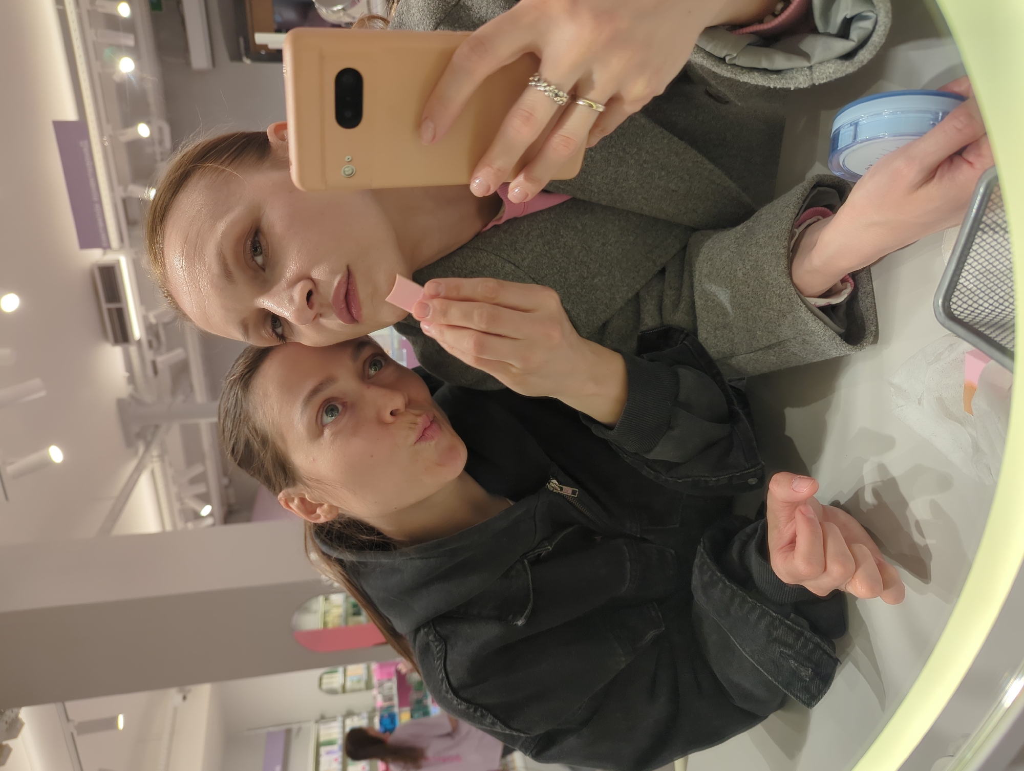 Two women take mirror selfie in Moscow
