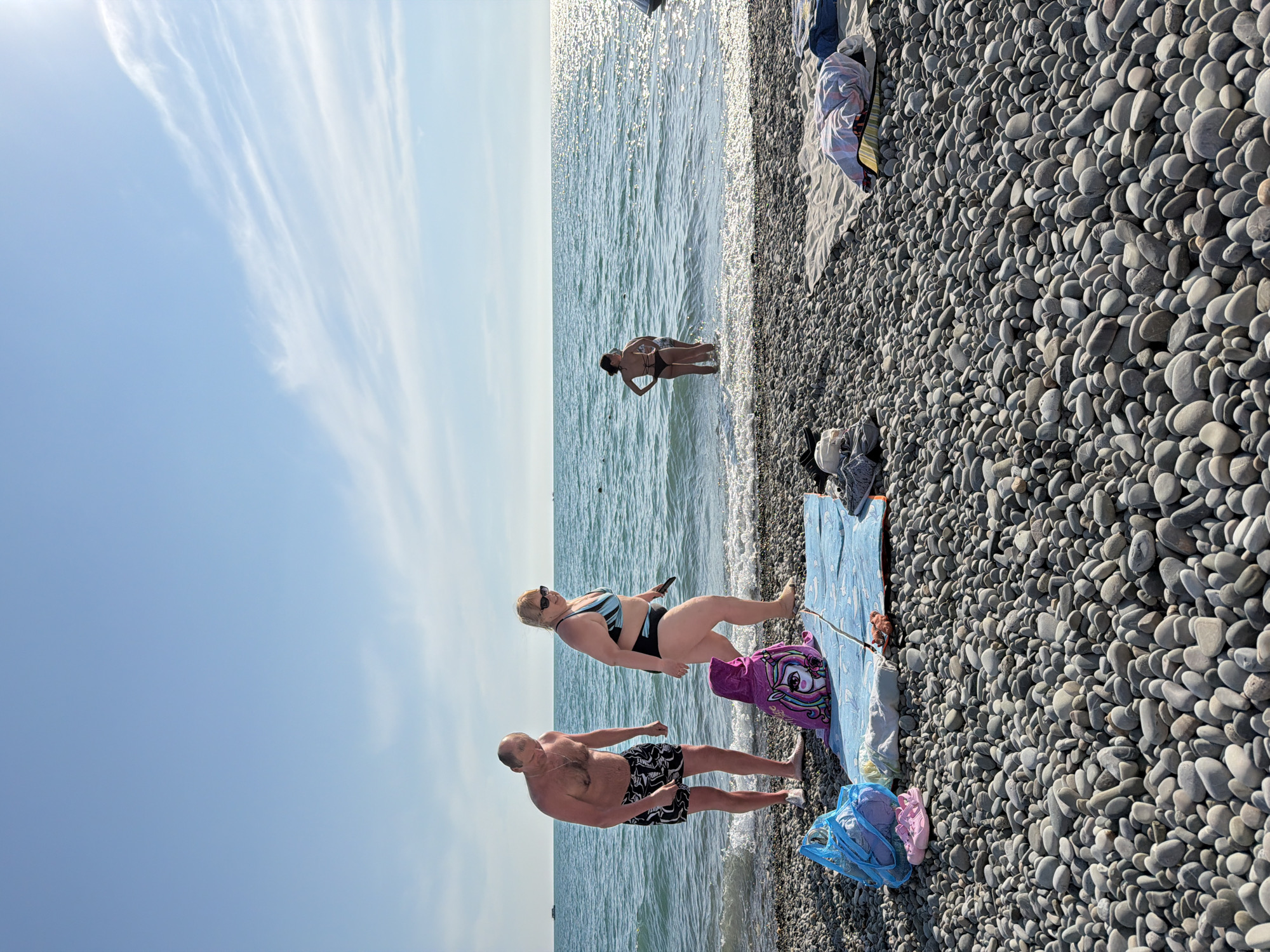 Beachgoers enjoy clear day at Vishnevka beach, Russia