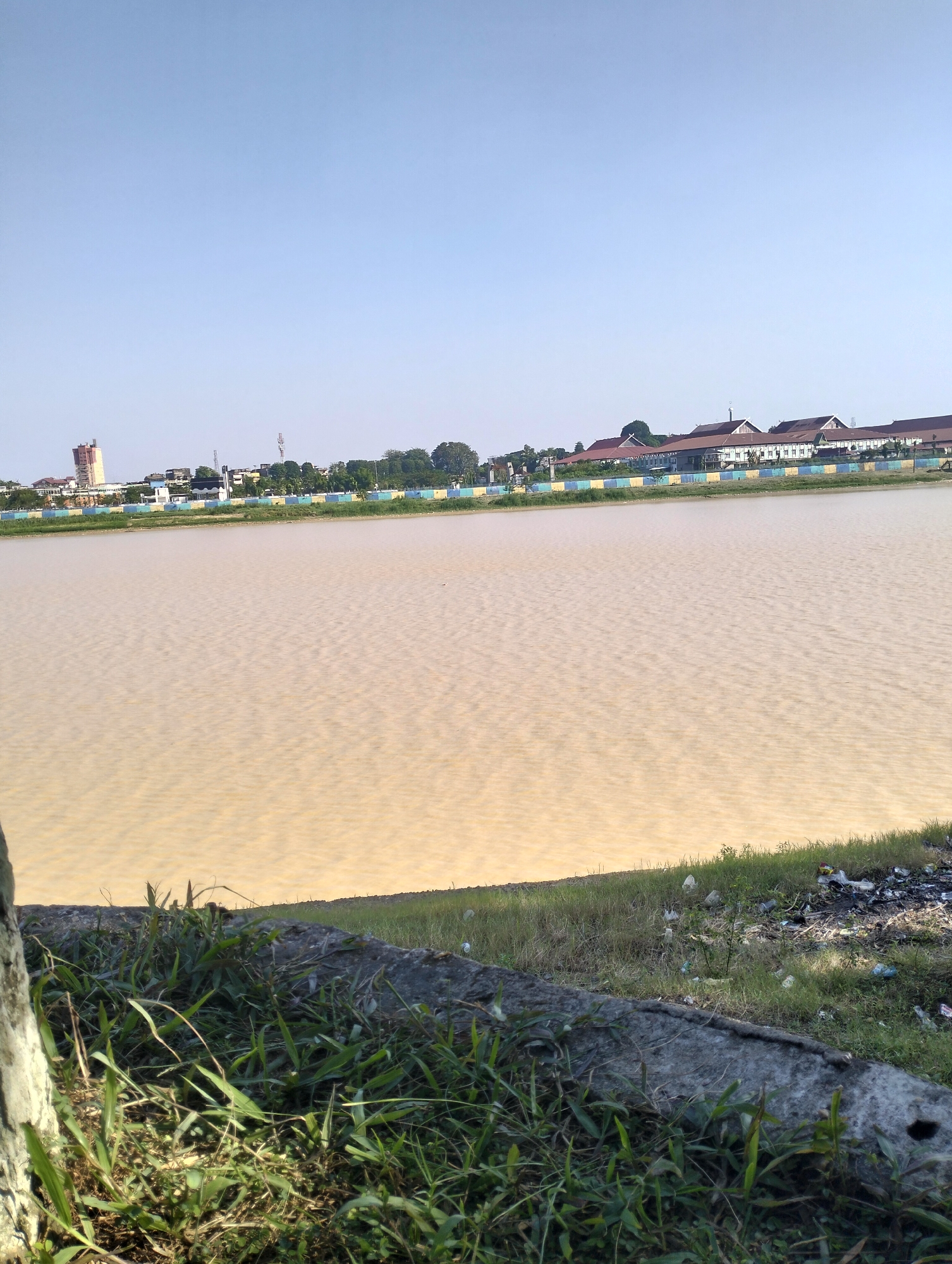 Muddy Batanghari River and its littered banks, Jambi