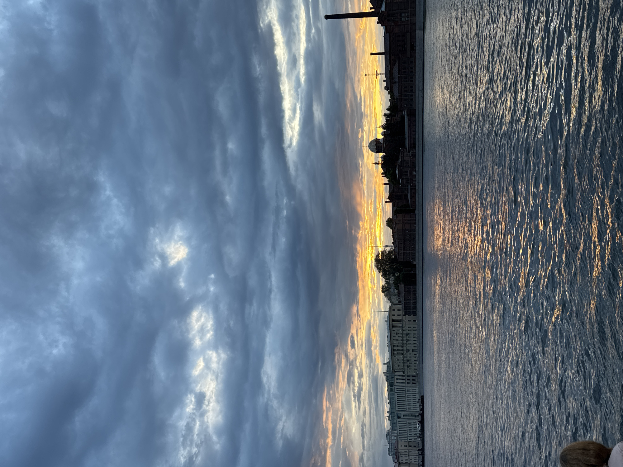 Neva River at dusk, storm clouds and a vivid sunset.