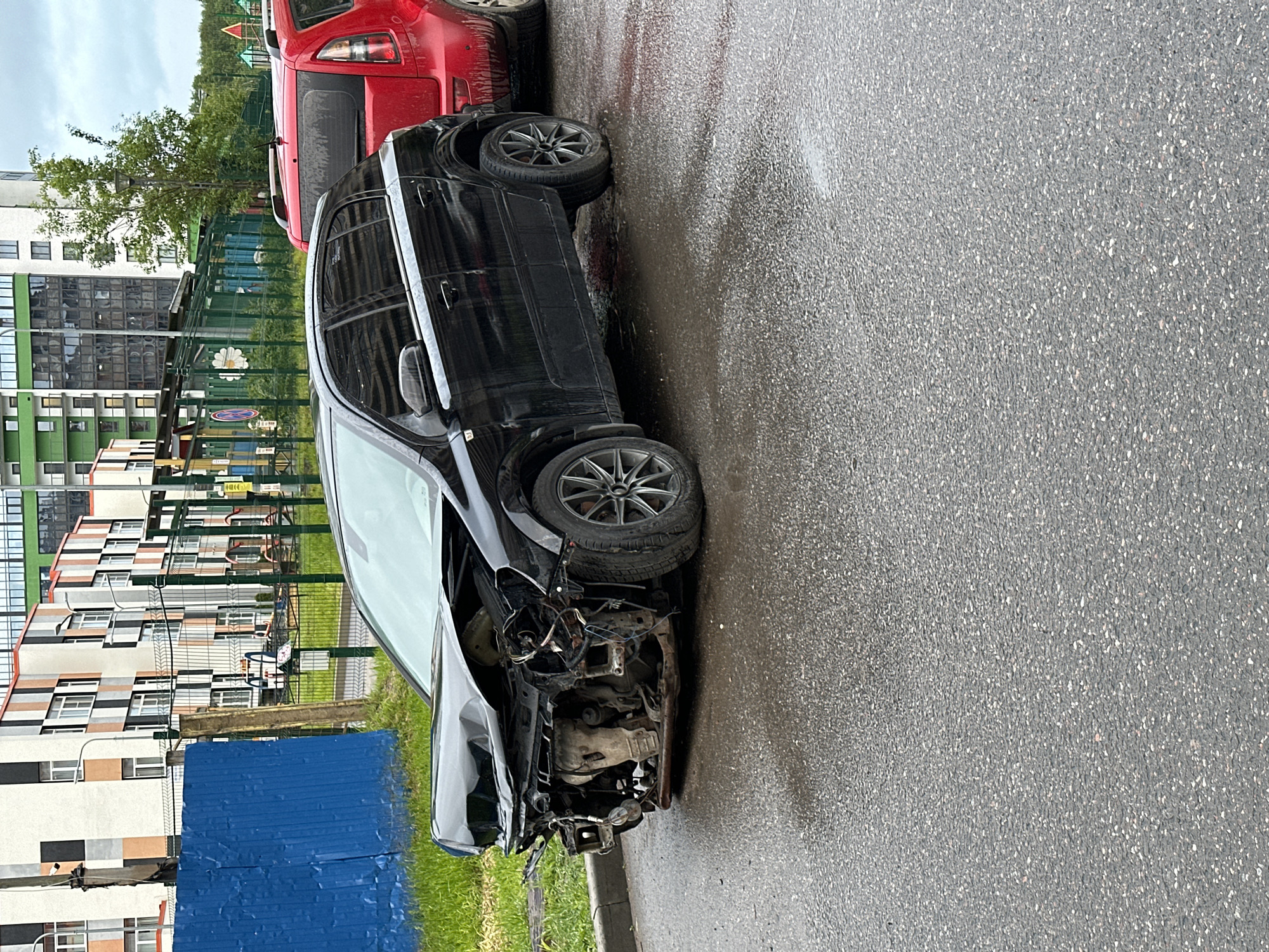 Car damage and wet streets observed in Kudrovo, Russia