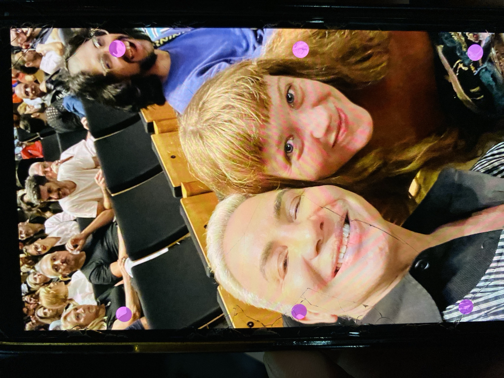 Three people photographed on screen during Buenos Aires auditorium event
