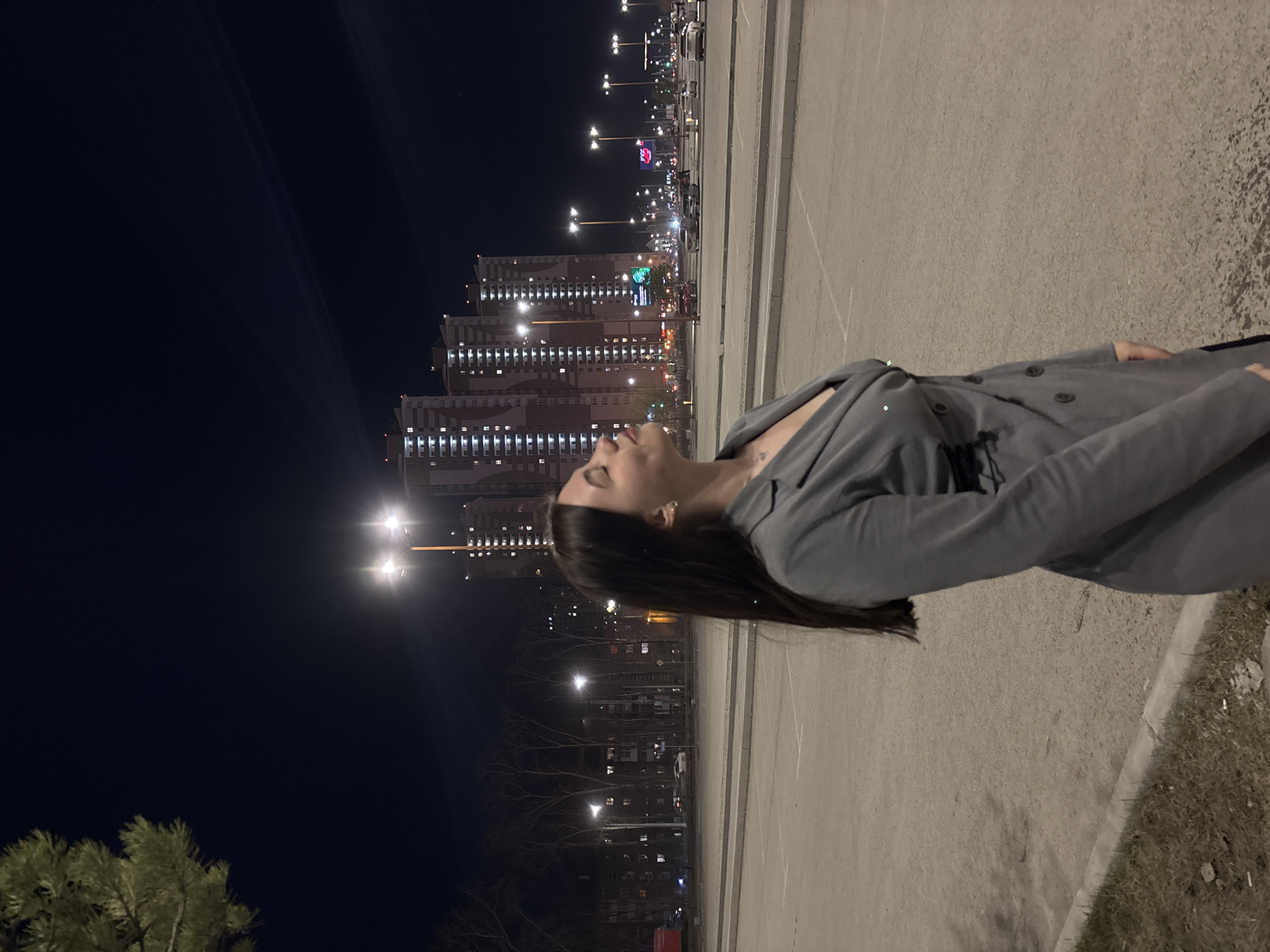 Woman poses for nighttime photos in downtown Perm