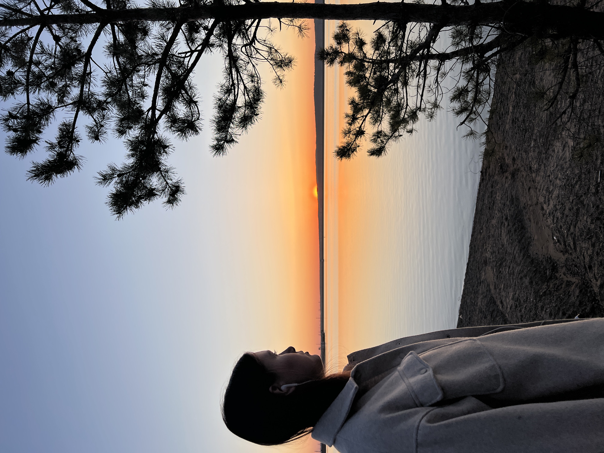 Sunset gathering documented along Chaikovsky waterfront with beverage toast