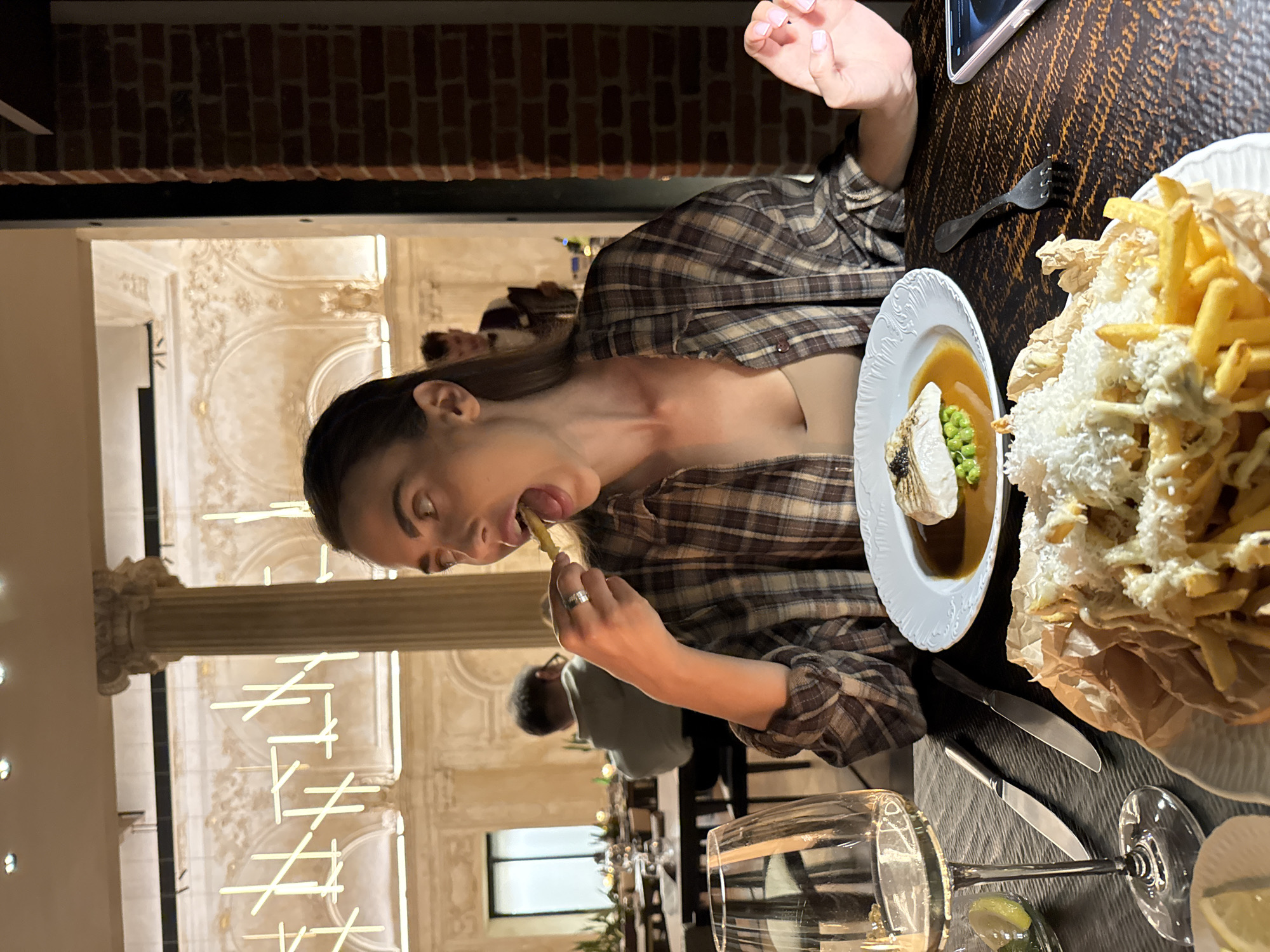 Woman enjoys casual dinner at upscale restaurant