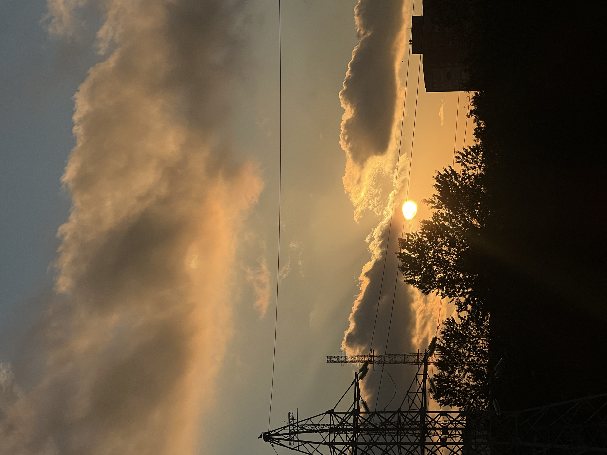 Sunset over Shushary's skyline, pylons and clouds lit up