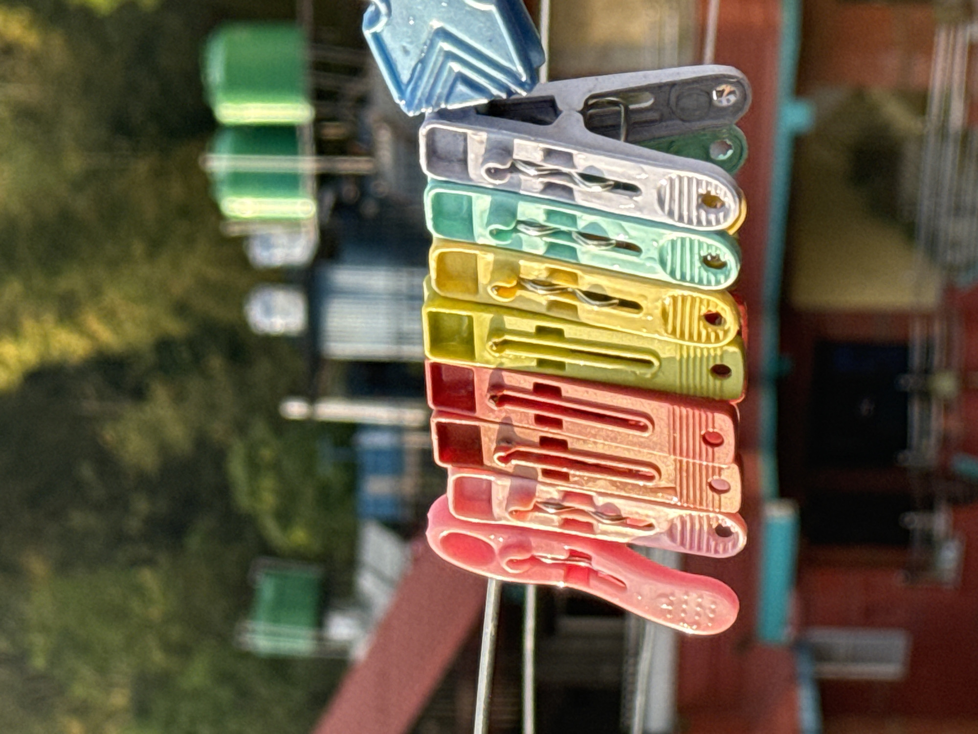 Colorful clothespins spotted on wire in Pokhara cityscape