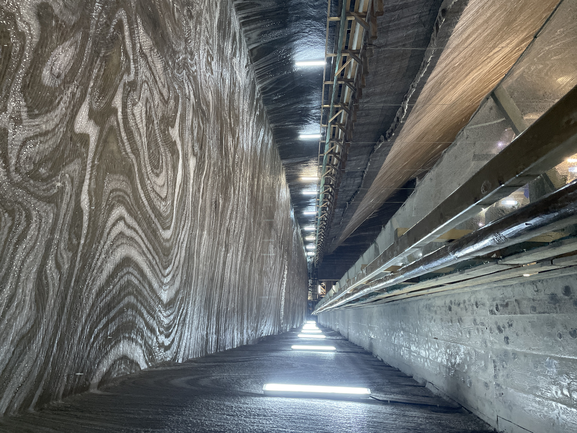Visitor documents Turda Salt Mine interior spaces in Romania