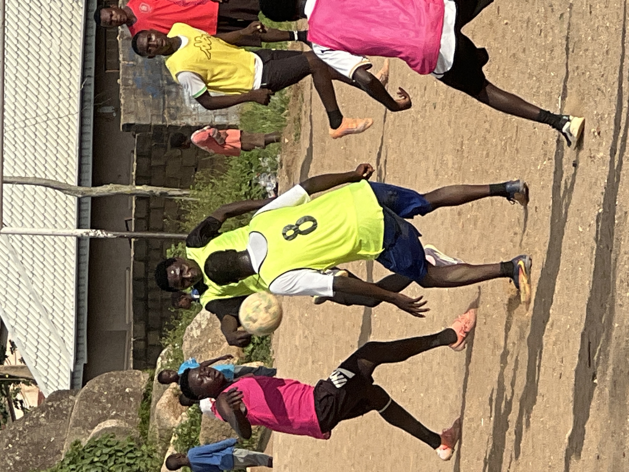 Pickup soccer on a rocky dirt field in Jos, Nigeria