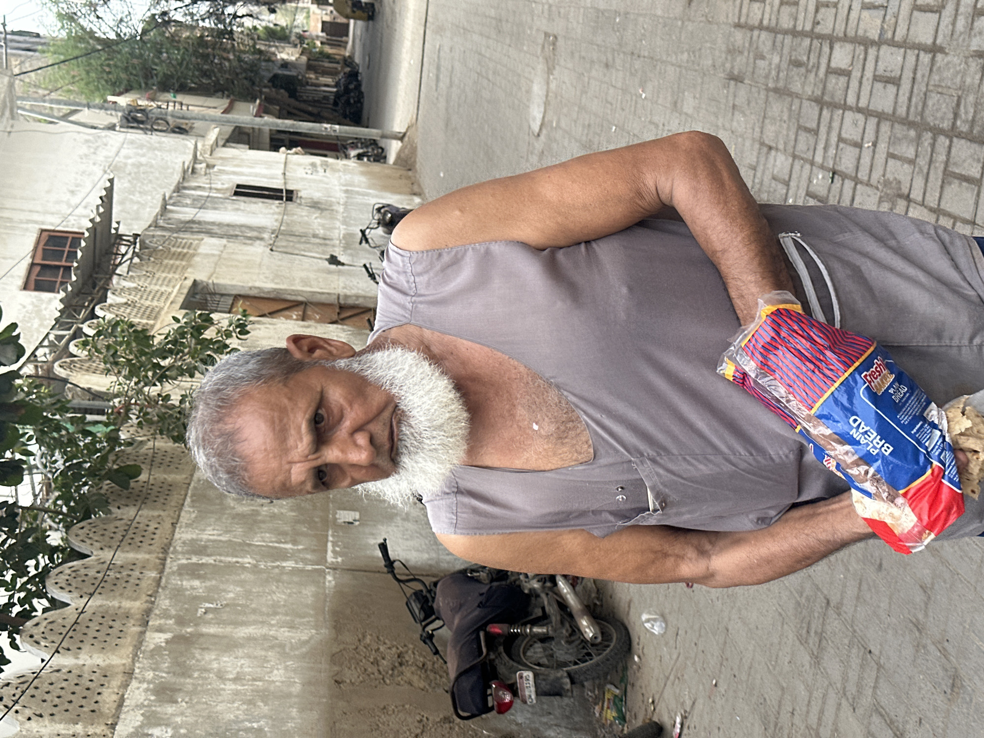 Quiet street moments across Karachi neighborhoods, early July