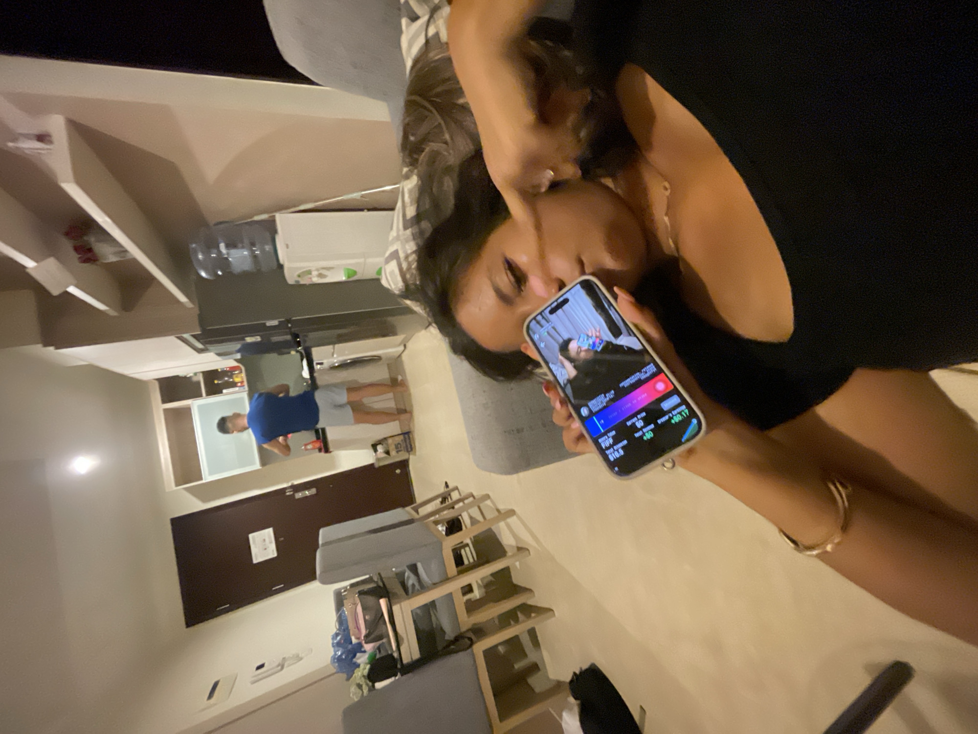 Couple relaxes on couch with phones in Jakarta apartment
