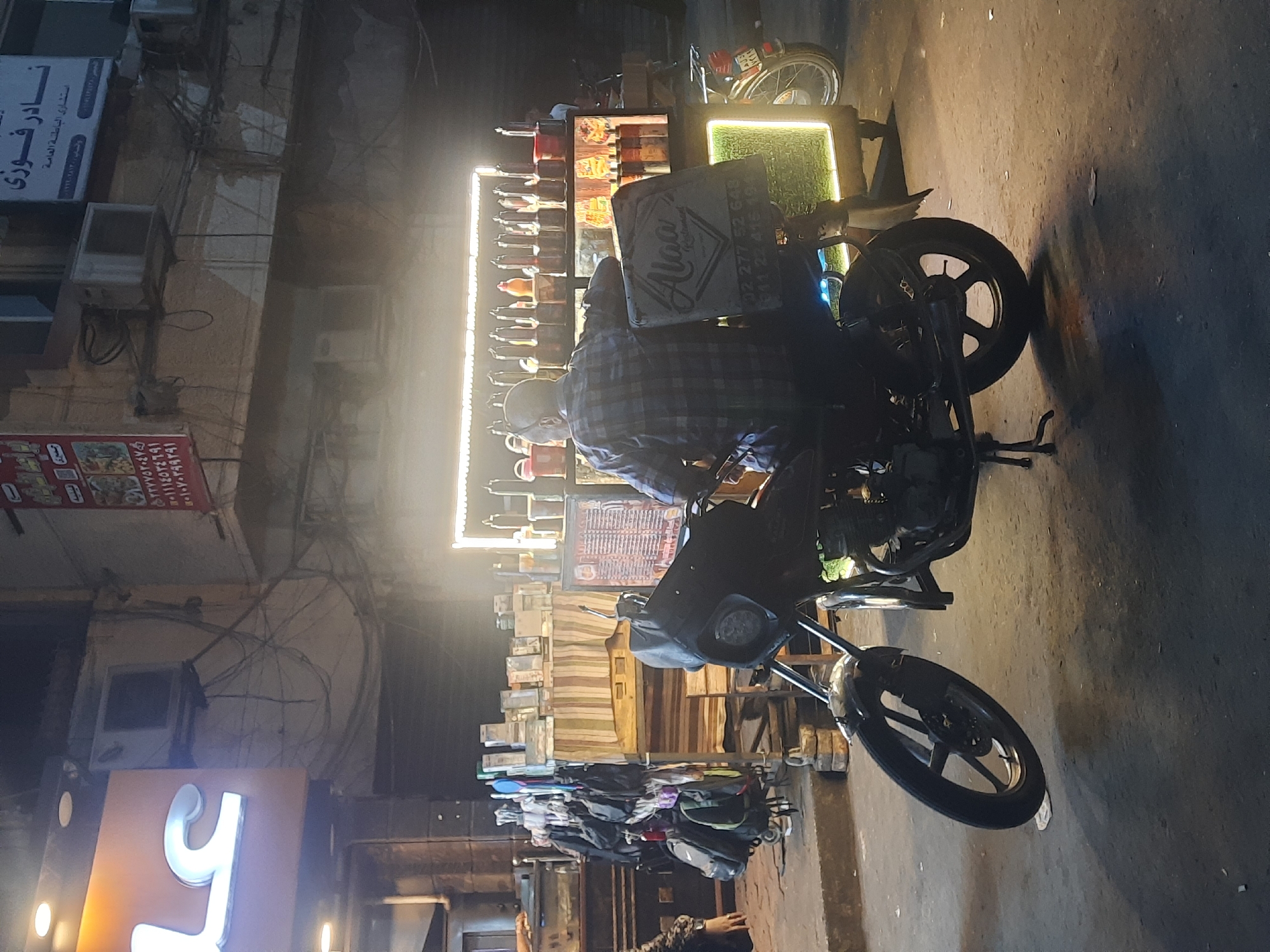 Motorcycle food vendor spotted on Cairo street at night