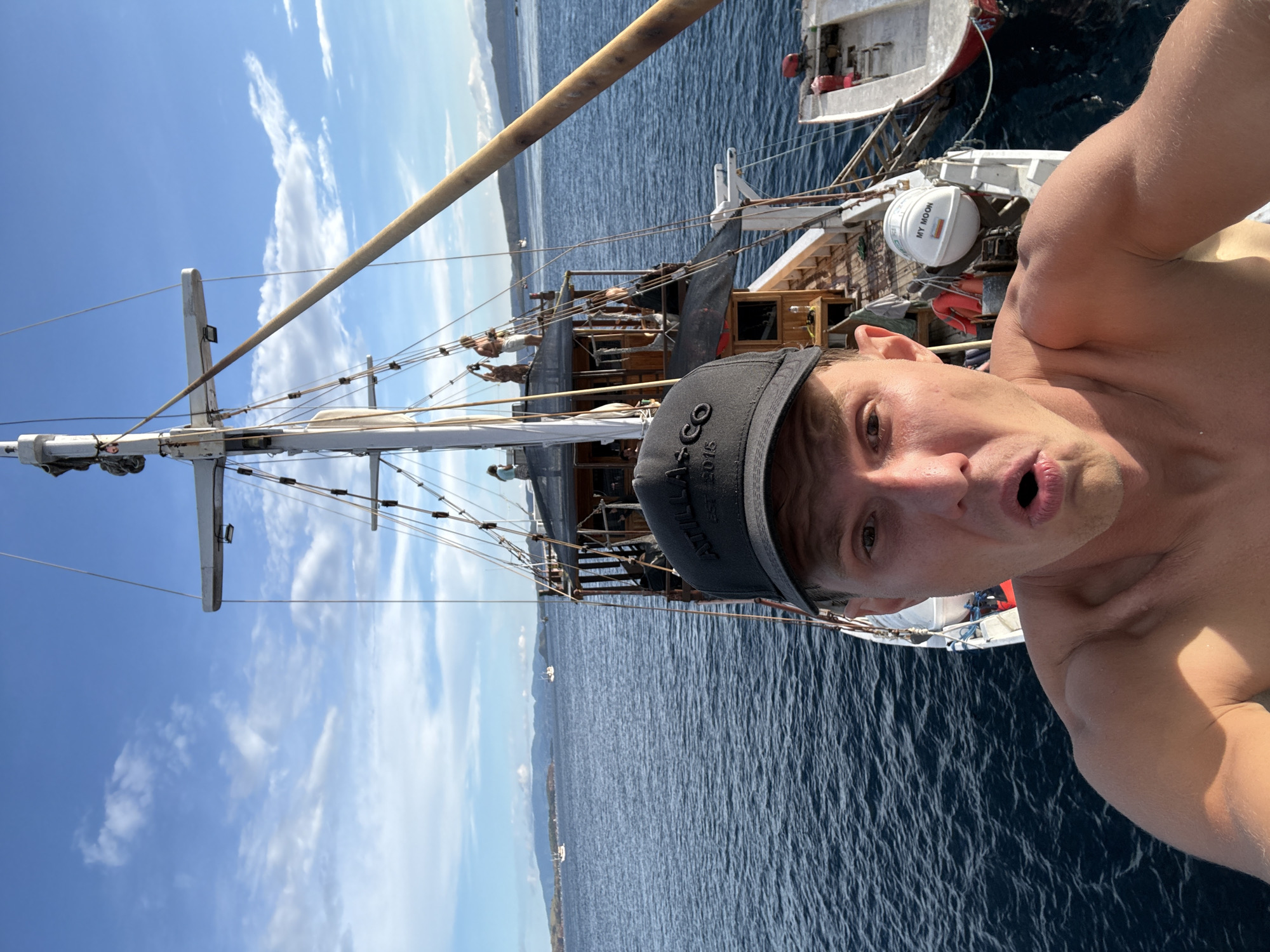 Man takes selfie aboard sailing ship near Pasir Putih