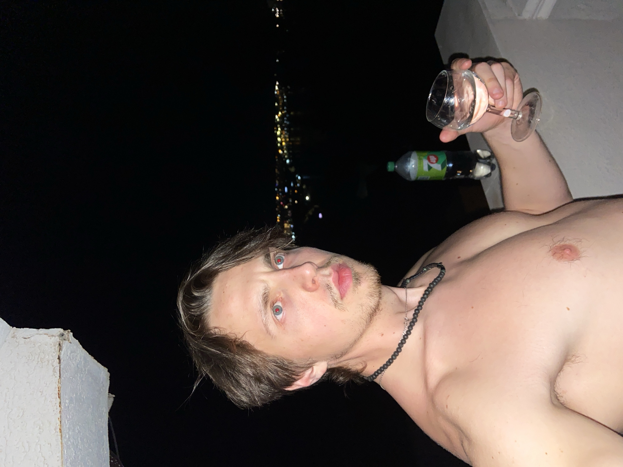 Man drinks wine on balcony overlooking Šušanj Montenegro