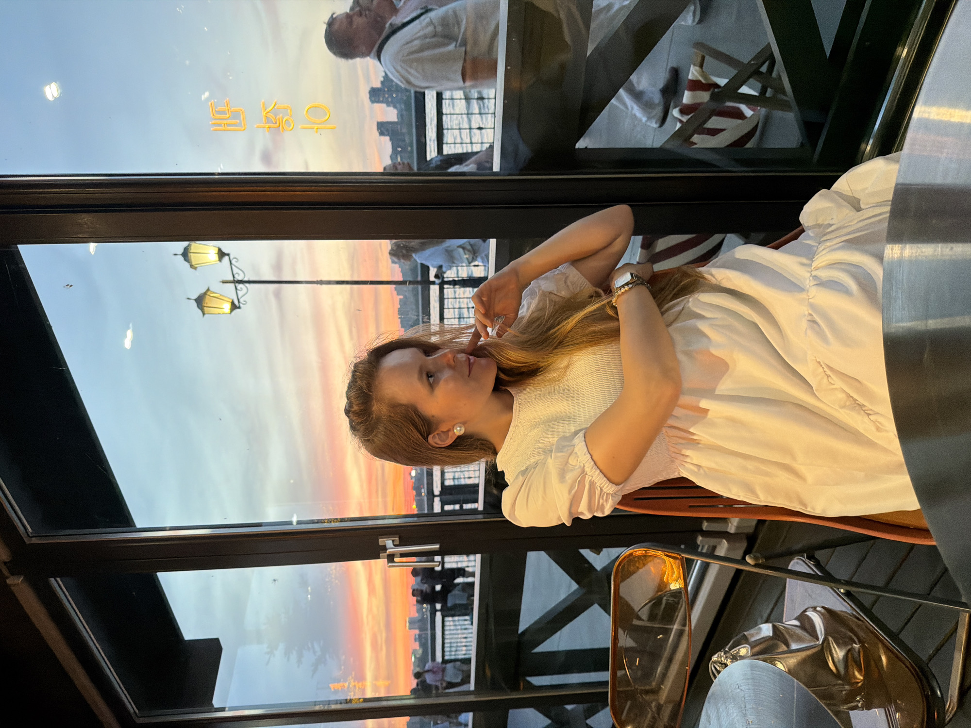 Kazan waterfront café at sunset, with a live street performer outside