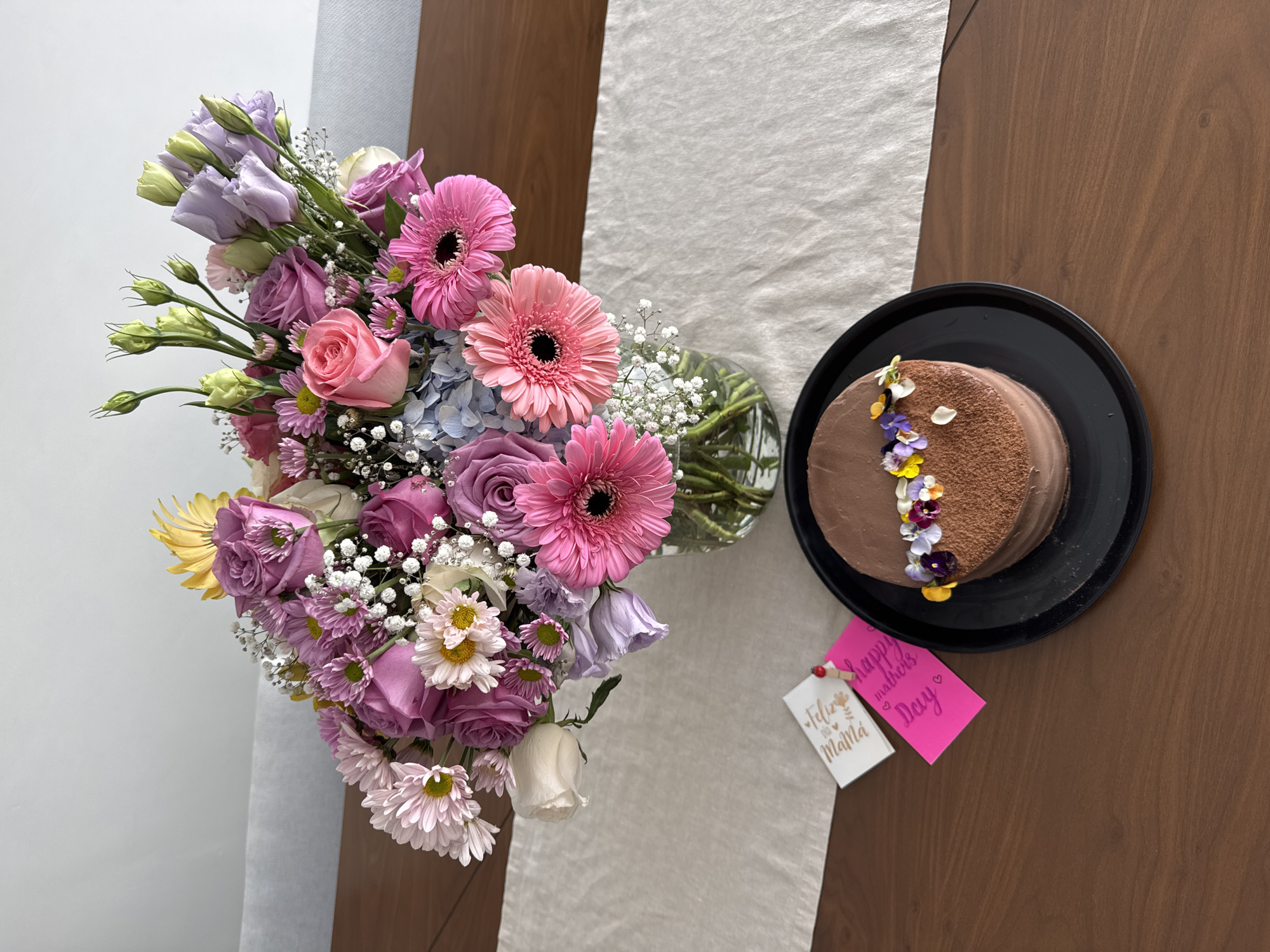 Woman photographs floral table arrangement in Puebla home