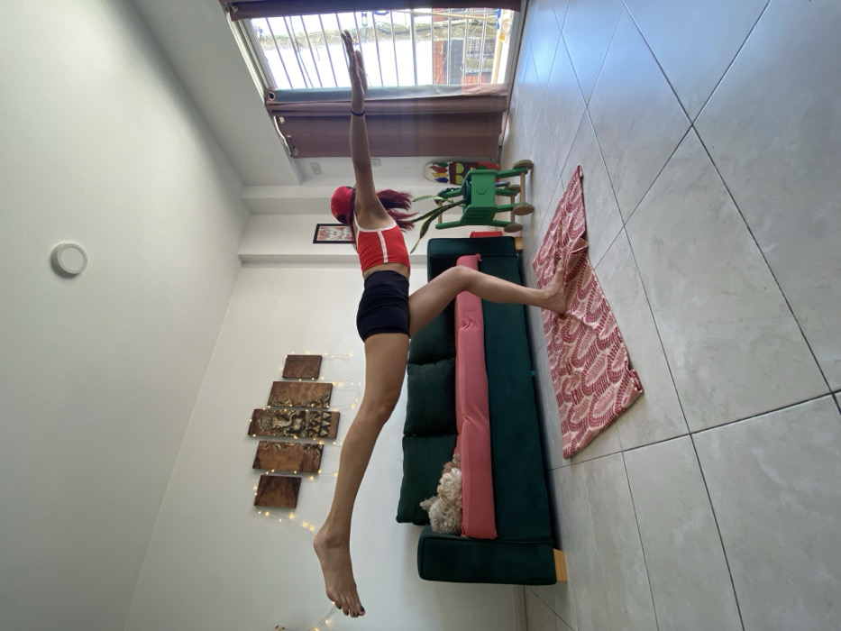 Woman conducts home yoga session with dog in Argentina