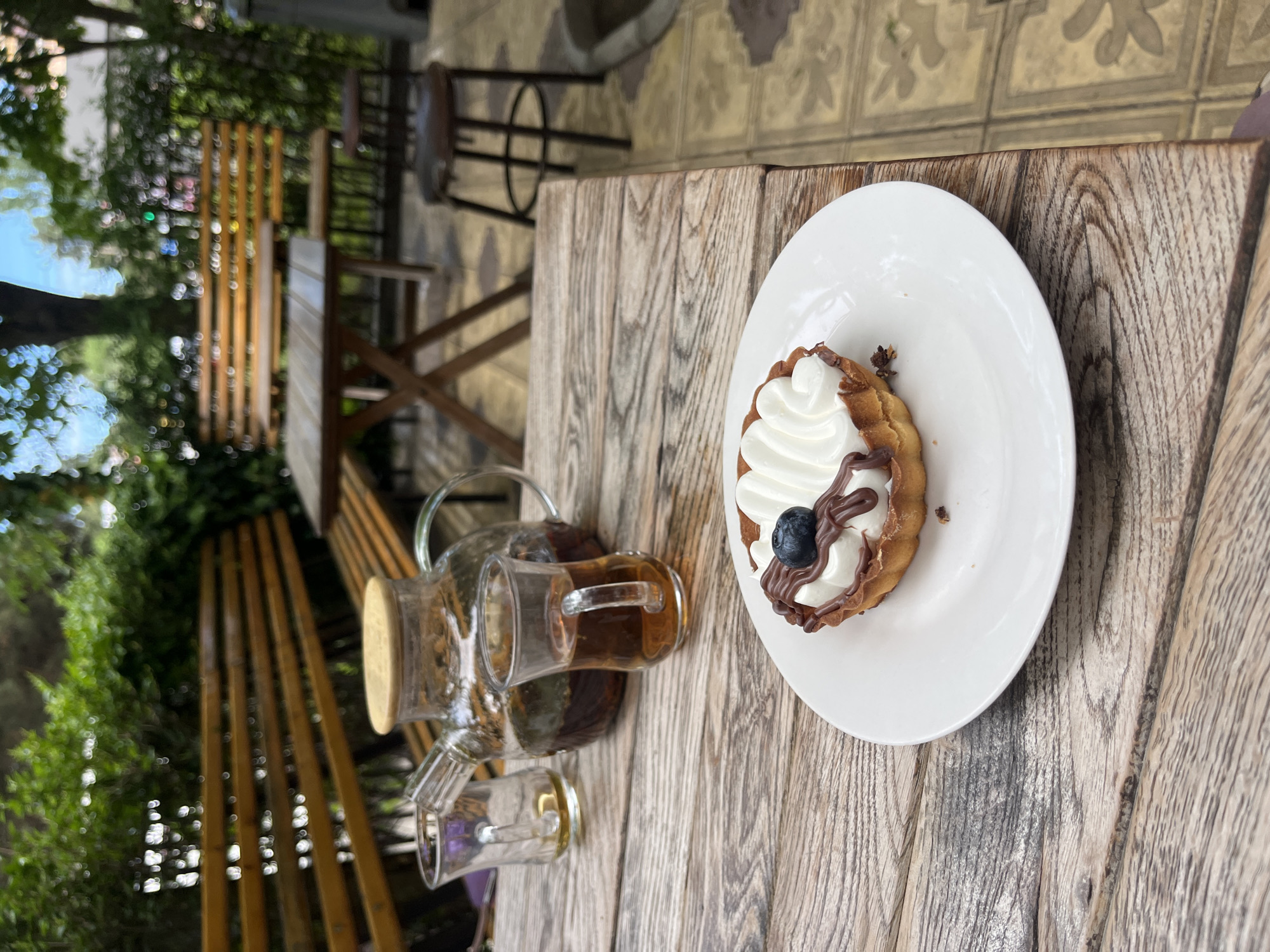 Children enjoy cake and tea at outdoor cafe in Kaspiysk