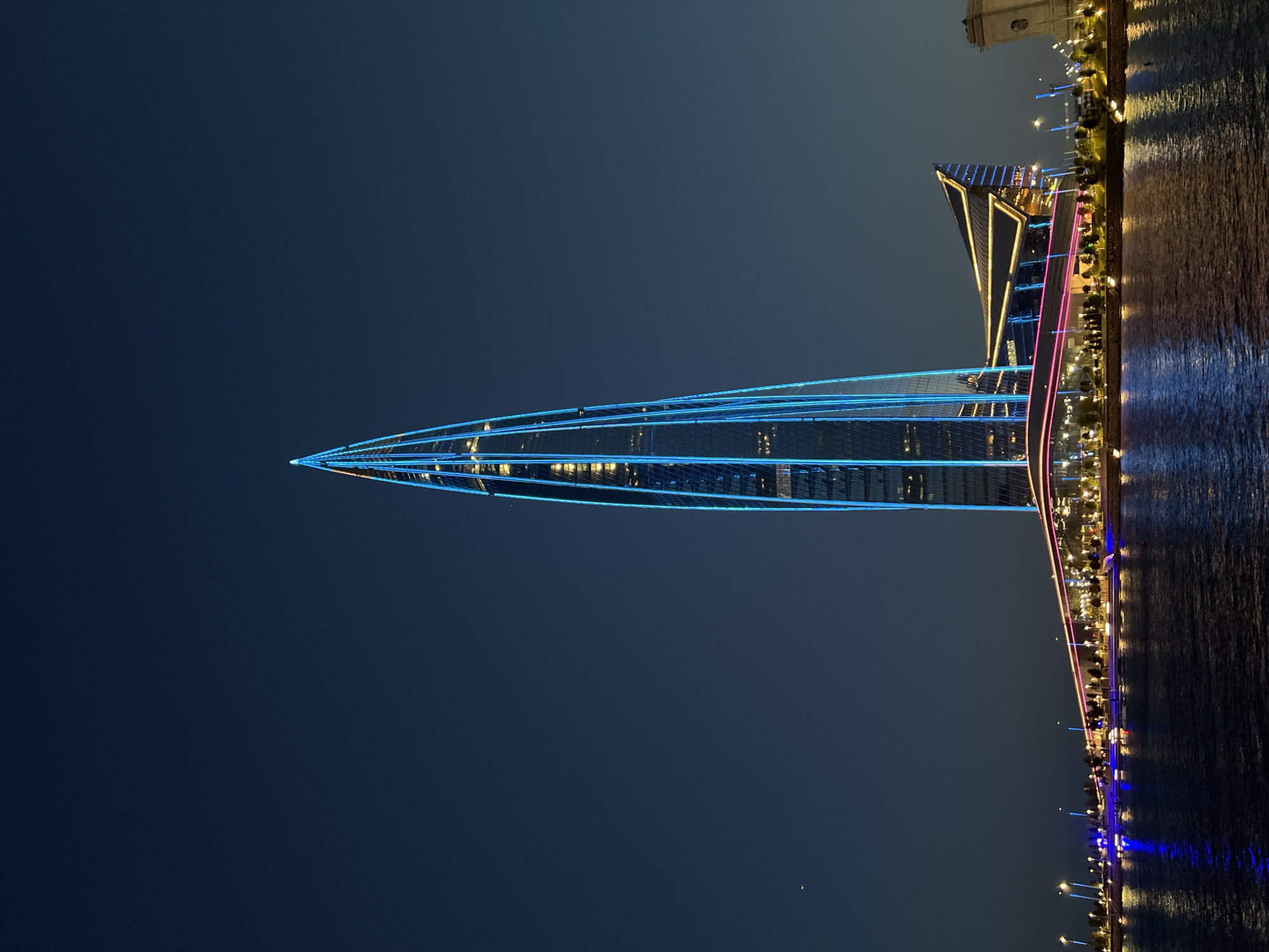 Lakhta Center glows blue over the Saint Petersburg waterfront at night