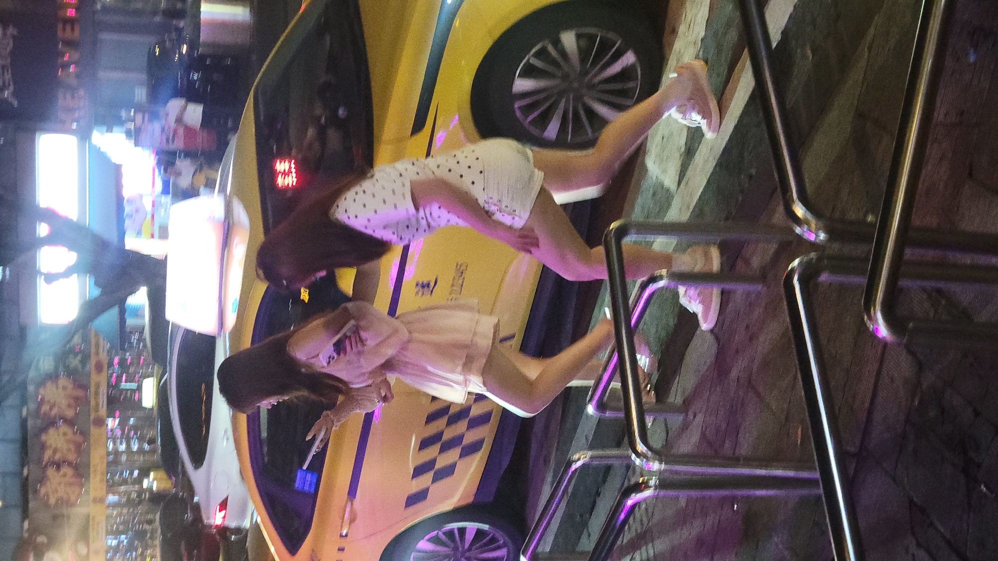 Nighttime urban street scenes with pedestrians and taxis documented