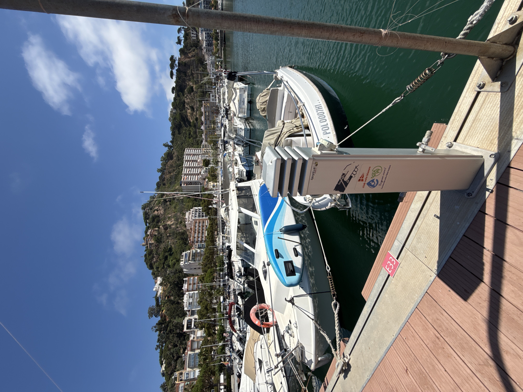 Busy summer morning at Blanes marina, jet skis and boats in motion