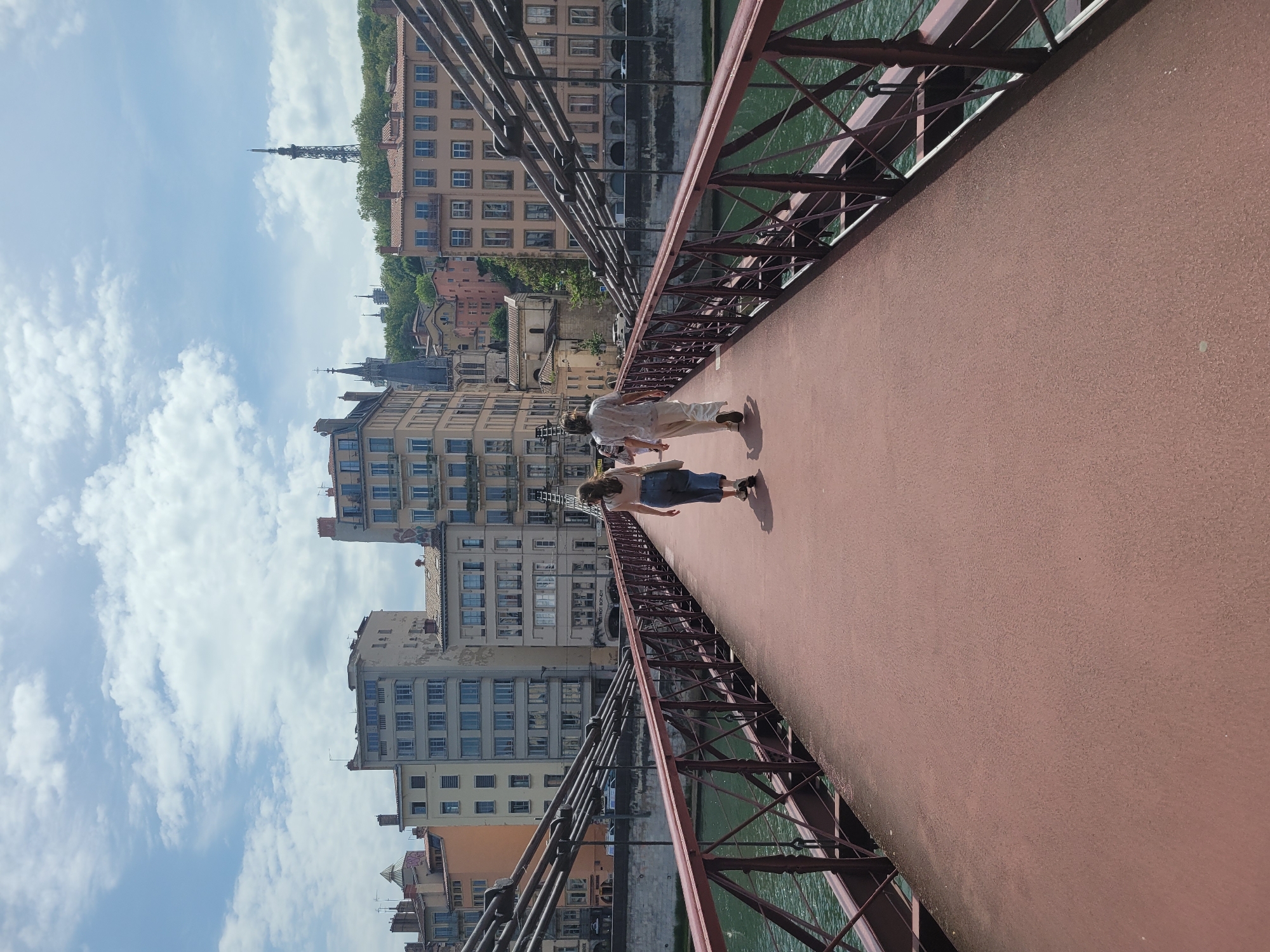 Two women walk pedestrian bridge in Lyon