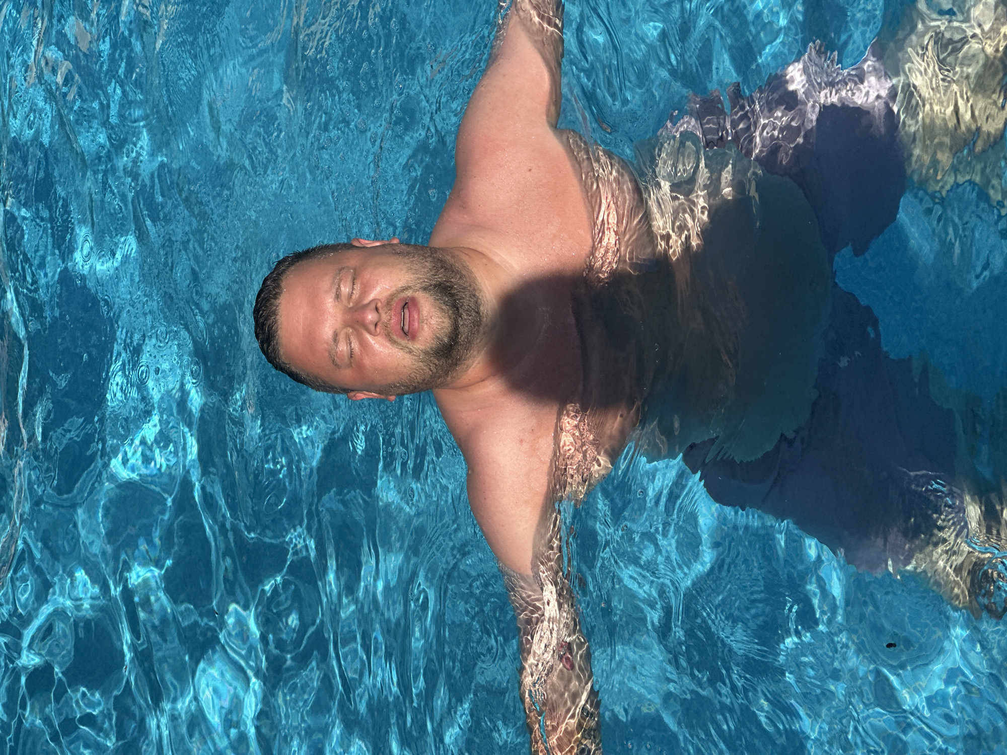 Father and toddler enjoy poolside afternoon in Spanish coastal town
