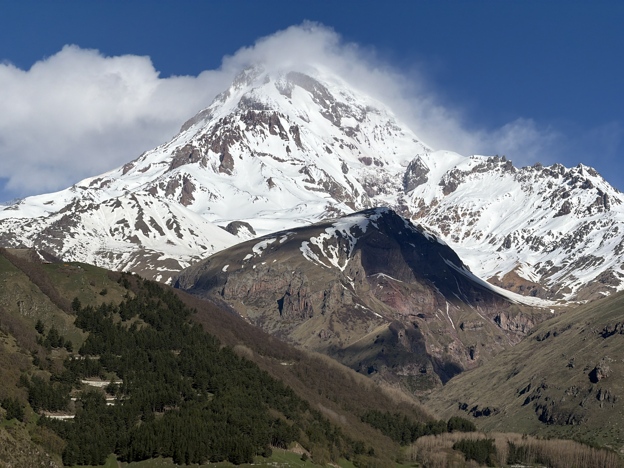 Snow-capped Mount Kazbek observed with clouded summit near Stepantsminda