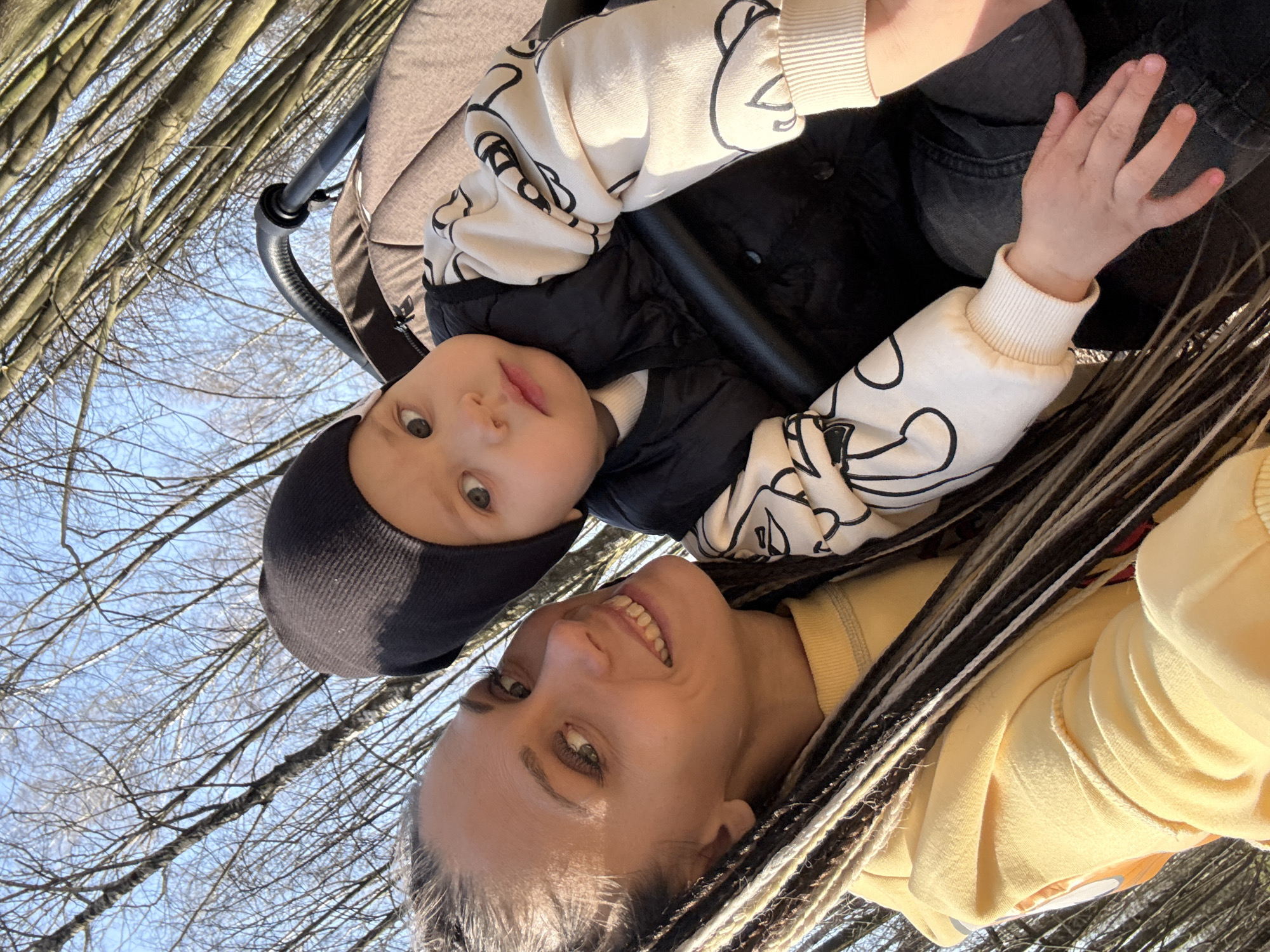 Woman with baby stroller photographed in wooded area near Bor