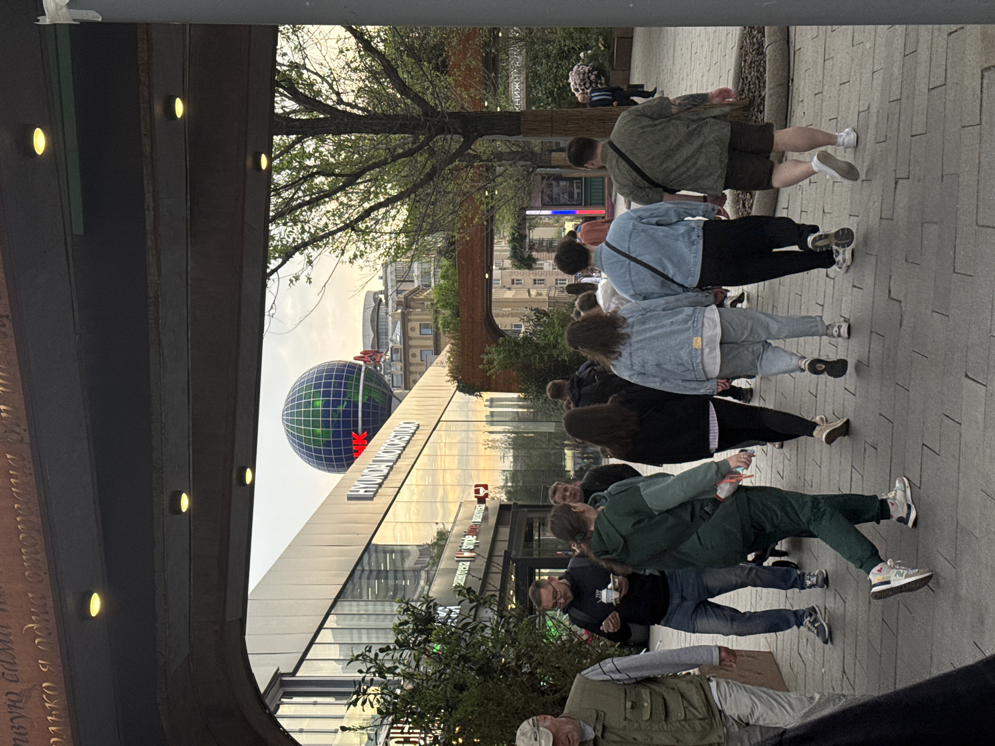 Pedestrians walk through Moscow public area, retail display observed