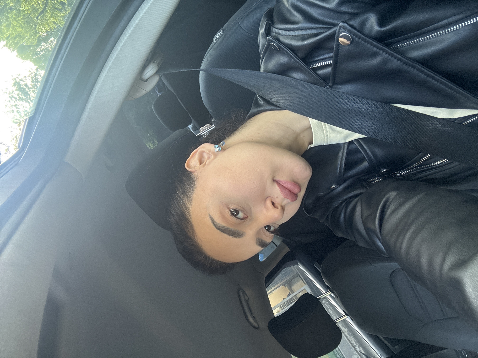 Woman in leather jacket photographed in car in Tbilisi