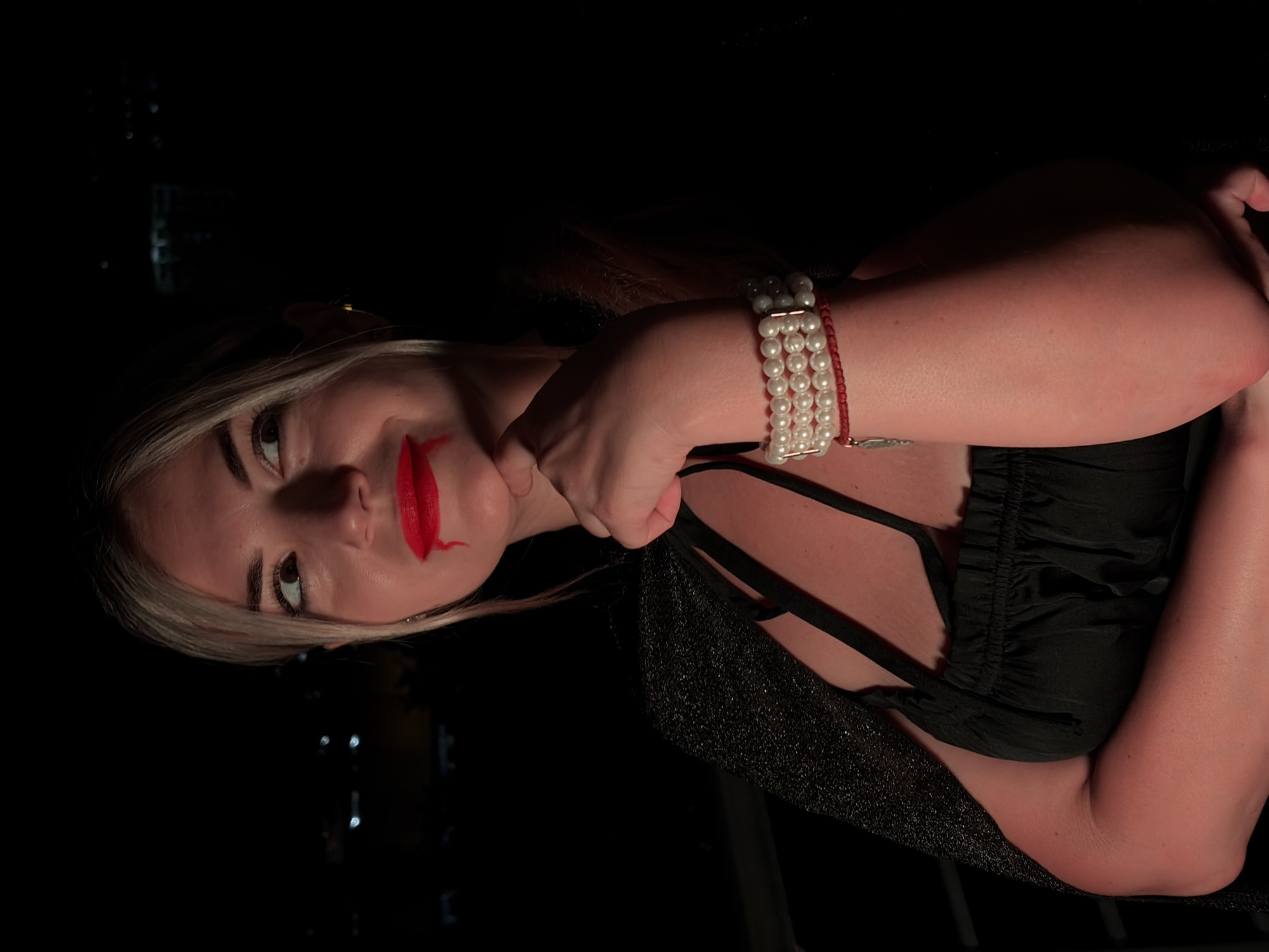 Dramatic costume look on a Budva balcony at night