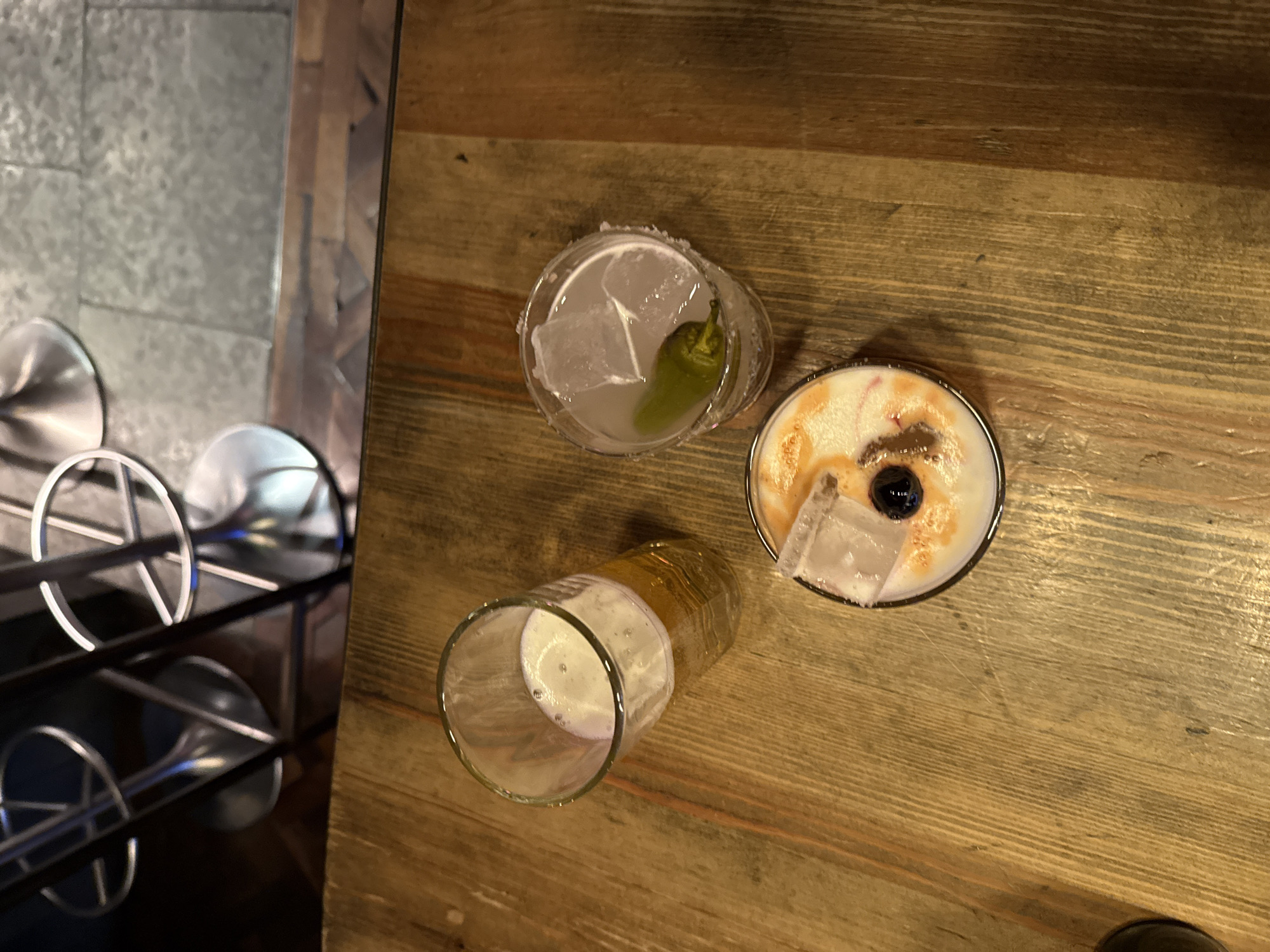 Three drinks served at London bar during evening hours