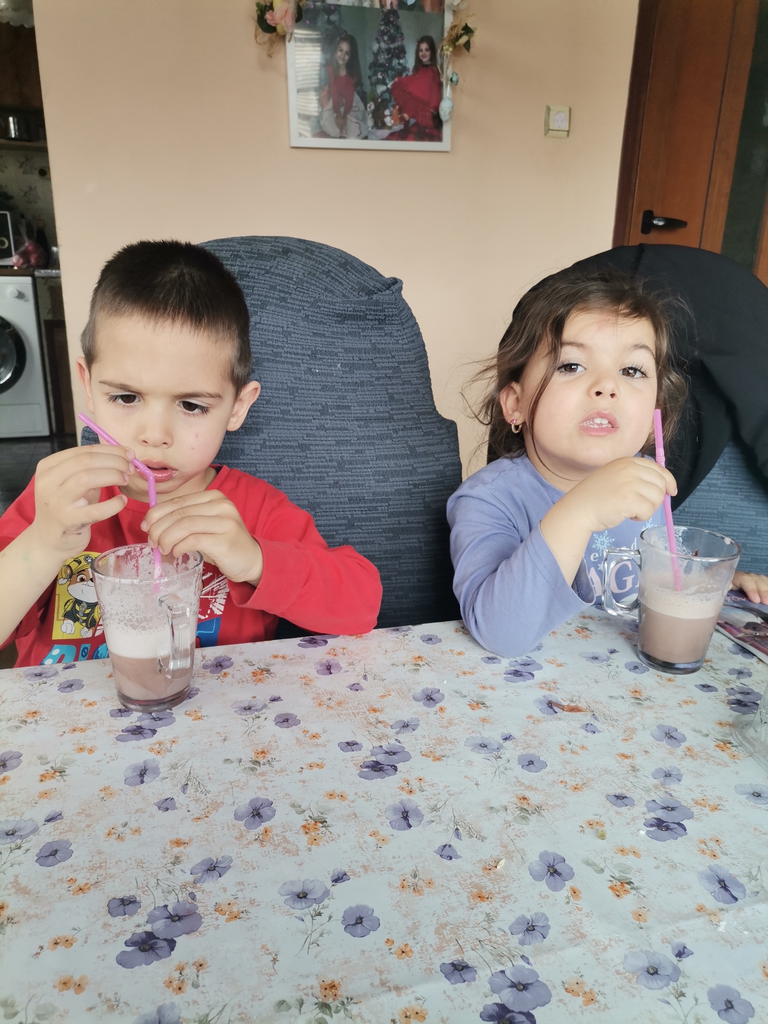 Children share morning drinks at home in Bulgarian village