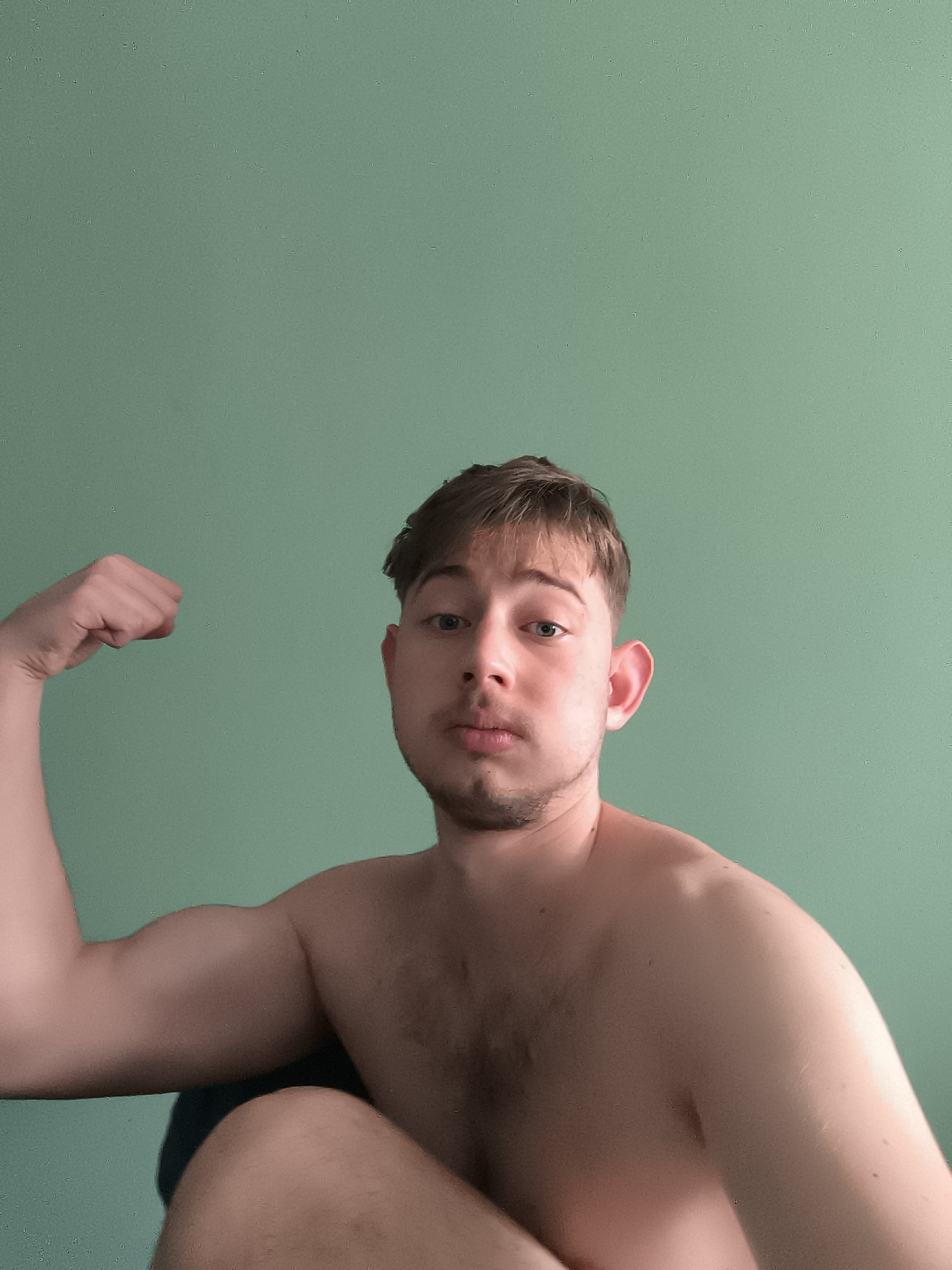 Man poses flexing for camera in Sofia indoor setting