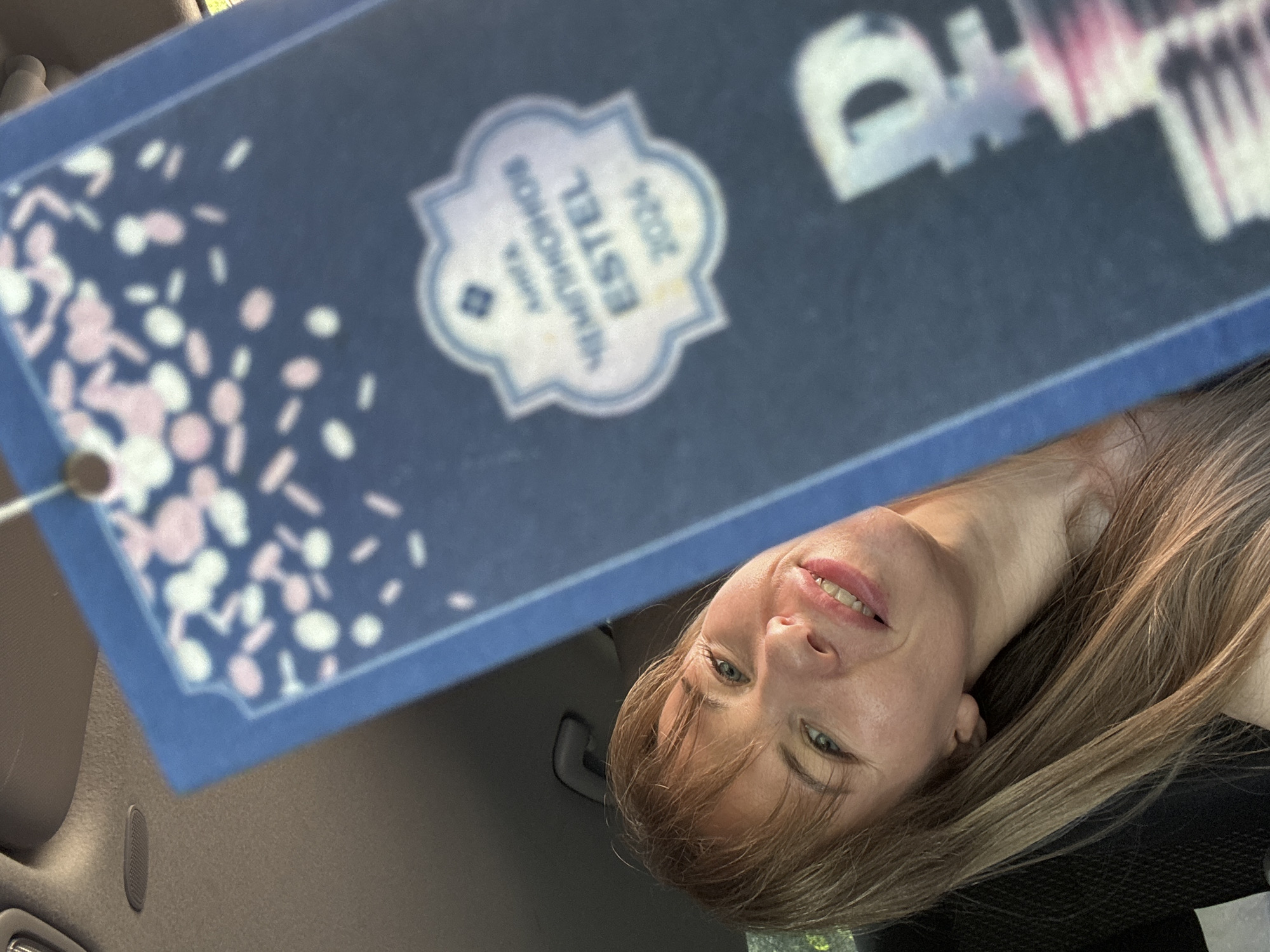 Woman displays car air freshener in Tolyatti vehicle