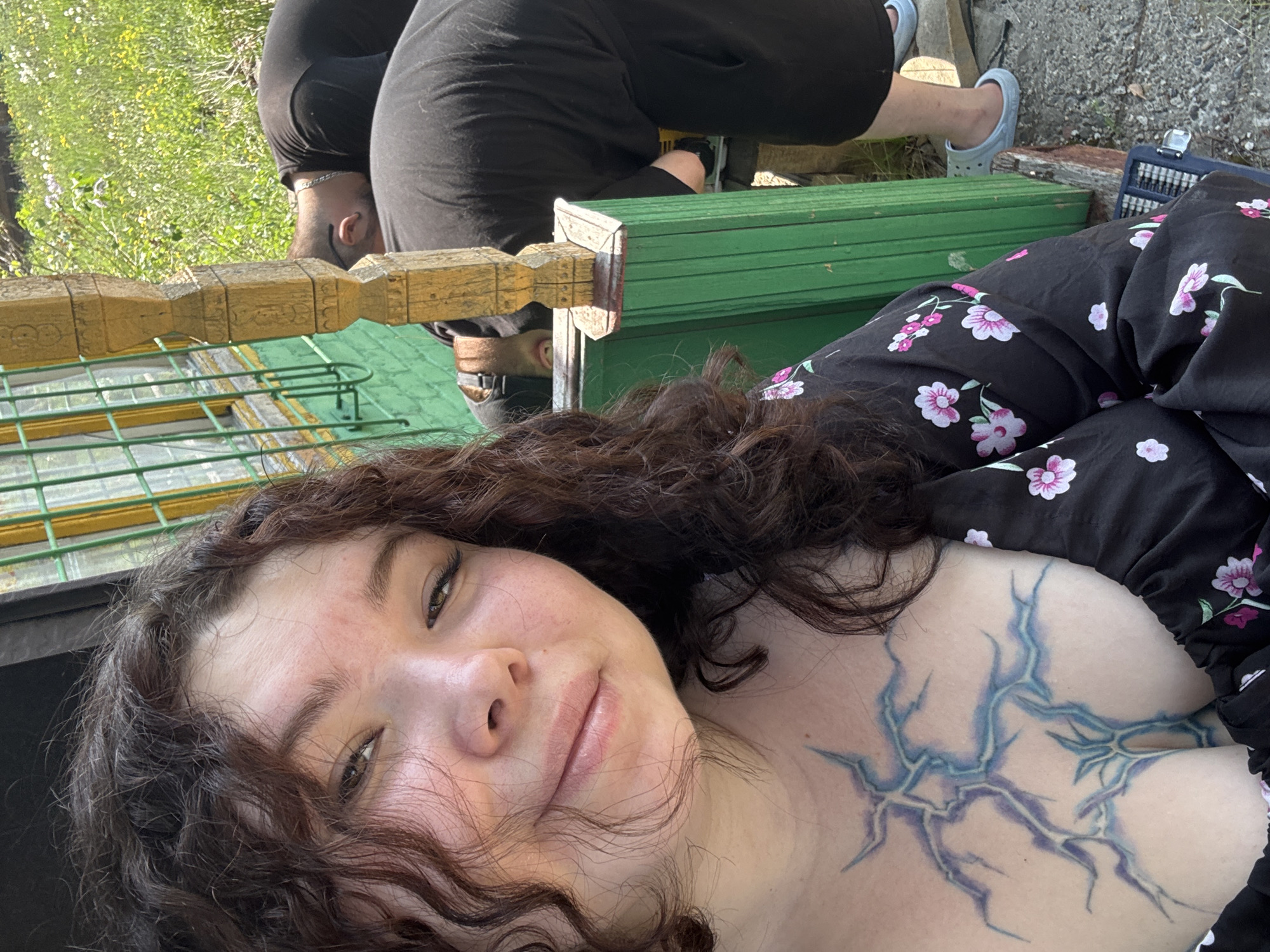Woman takes selfies outside wooden house in Surgut